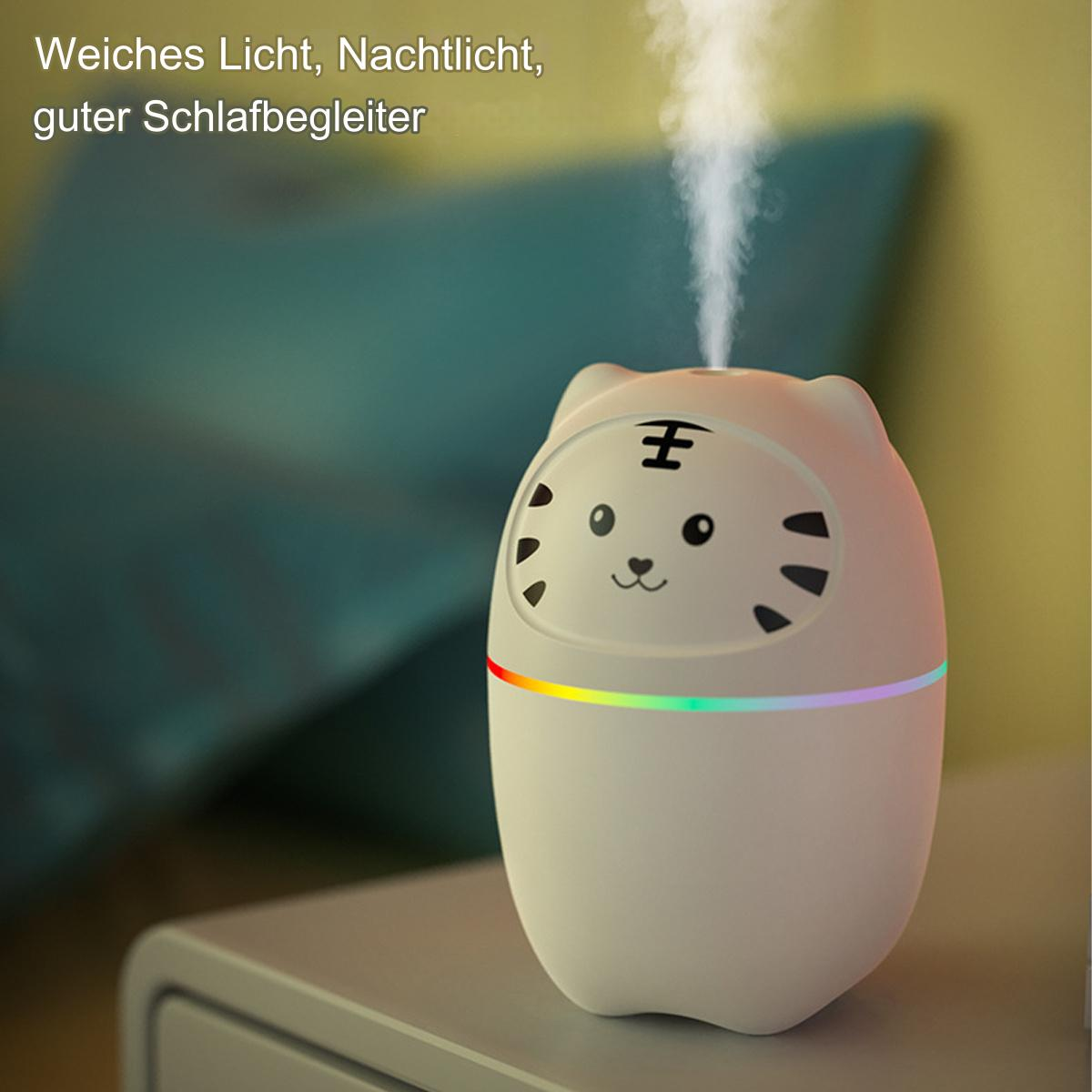 Ein weißer, katzenförmiger Luftbefeuchter mit aufsteigendem Dampf, der auf einem grauen Tisch steht.