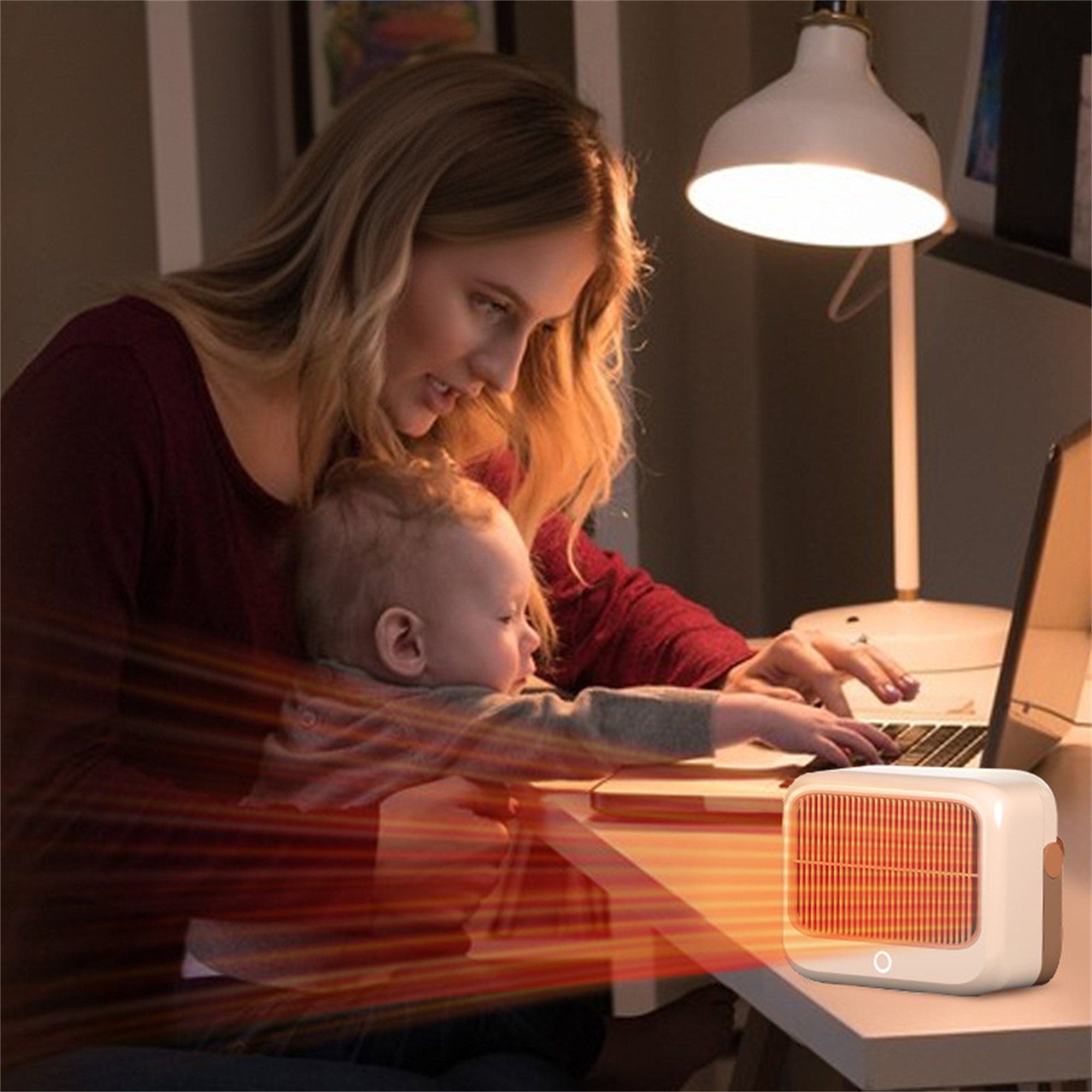 Frau mit Baby in der Nähe eines Heizgeräts und eines Laptops.