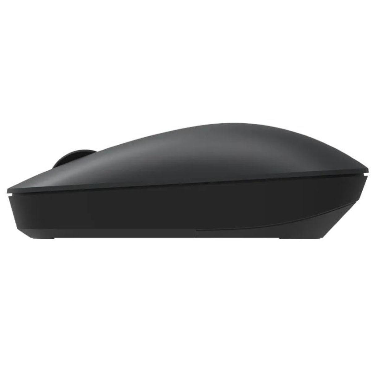 Une souris sans fil noire, vue de côté, montrant sa forme et son design.