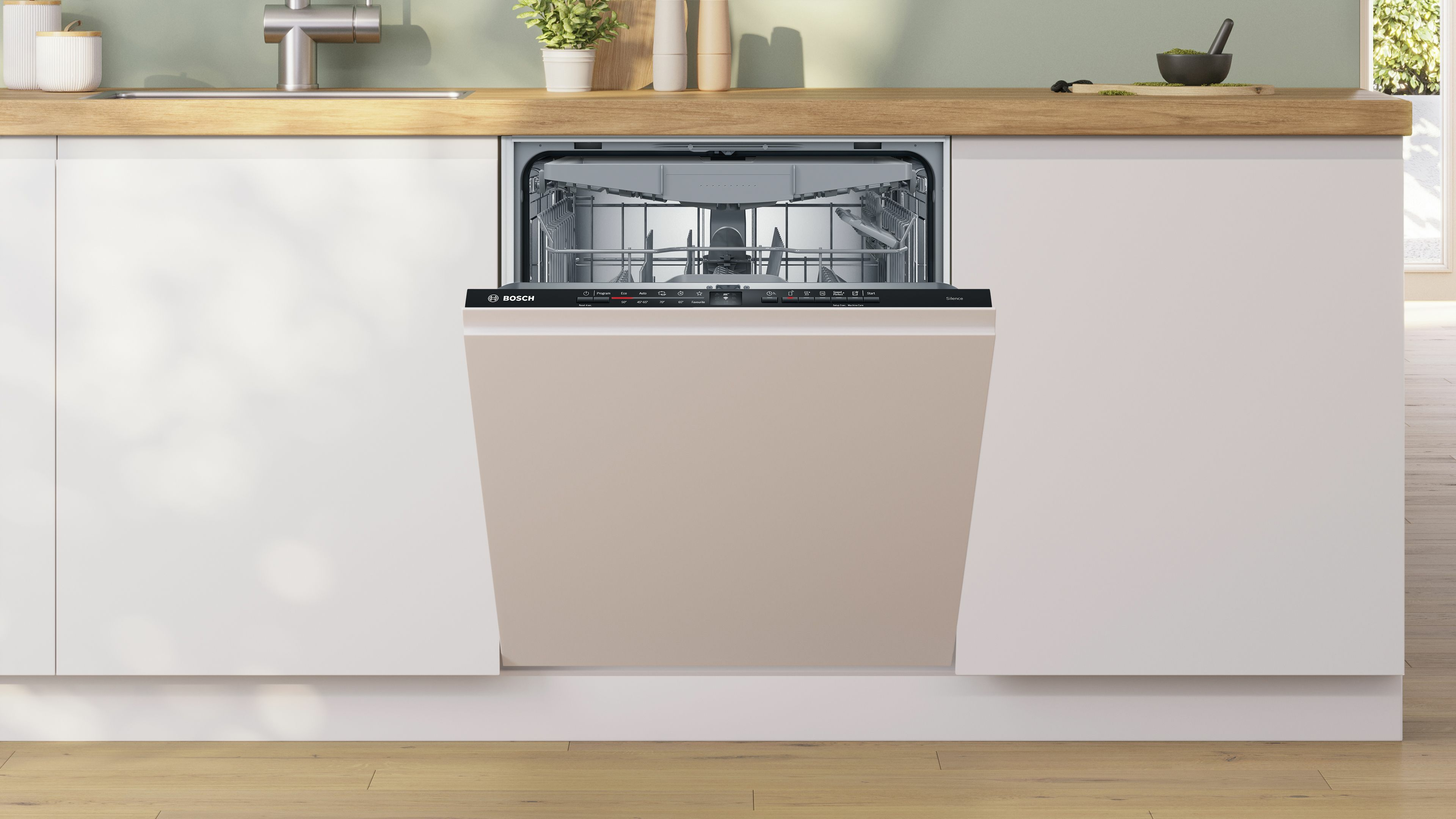 Geschirrspüler in einer Küche eingebaut. Beige Frontplatte. Arbeitsplatte und Schränke im Hintergrund.