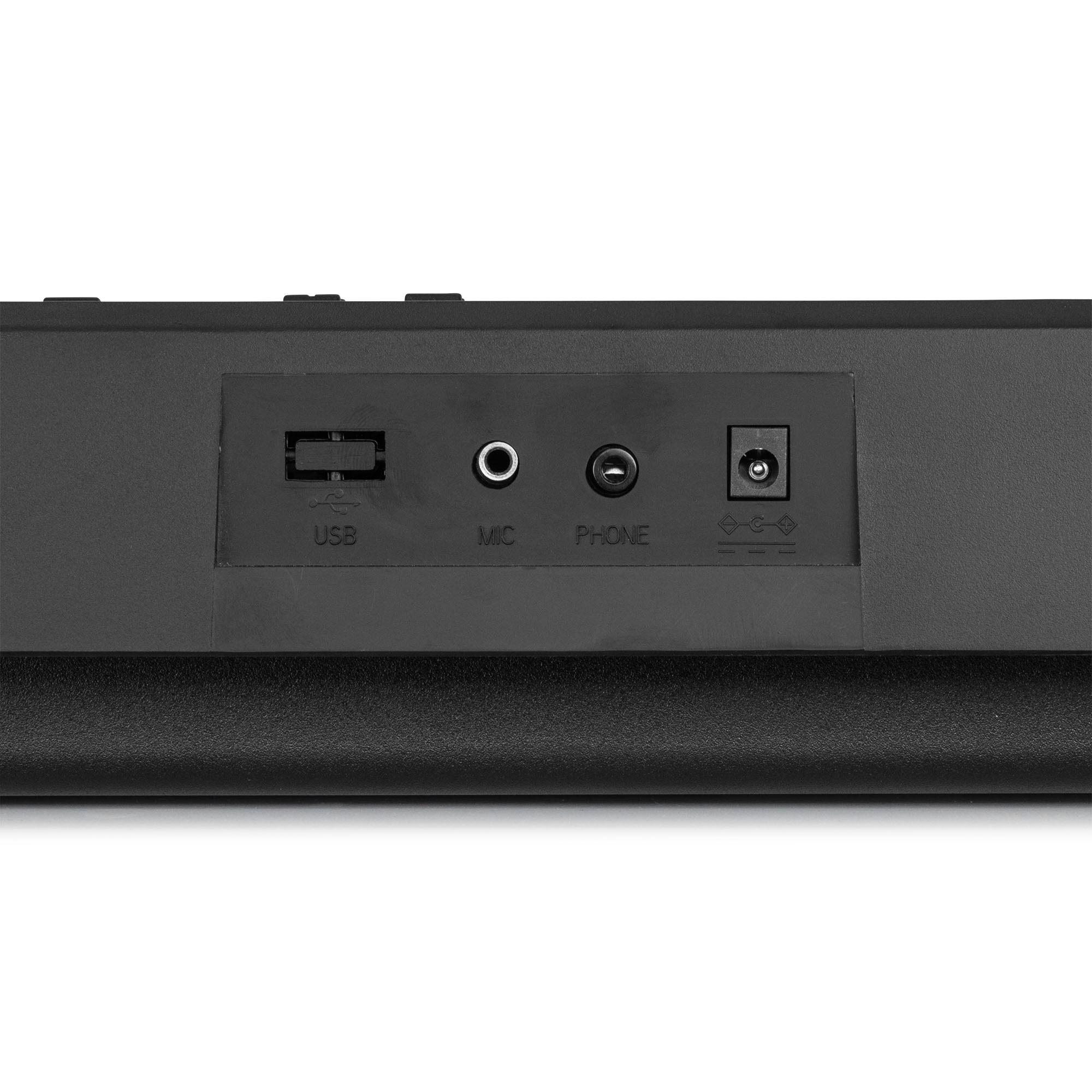 Een close-up van het achterpaneel van een zwart toetsenbord met USB-, microfoon-, telefoon- en voedingspoorten.