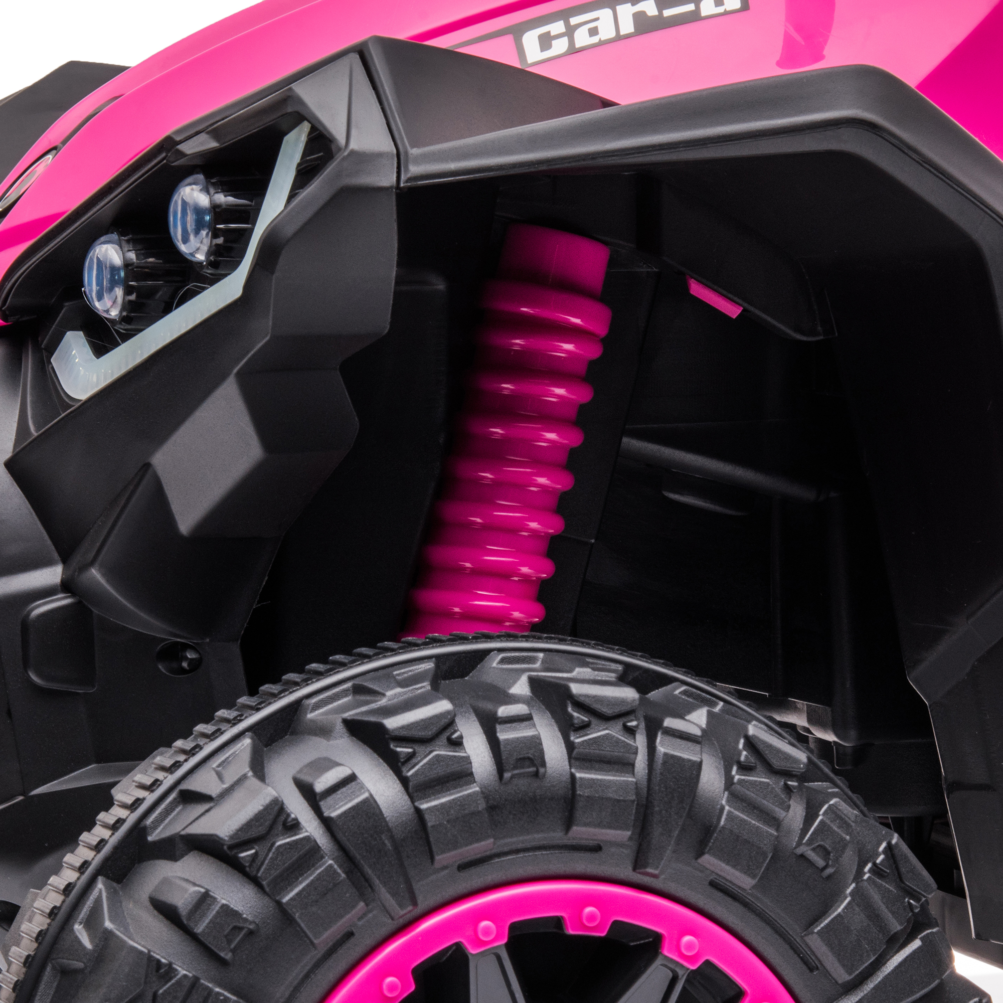 Primo piano di ATV rosa con pneumatico nero e sospensioni rosa.