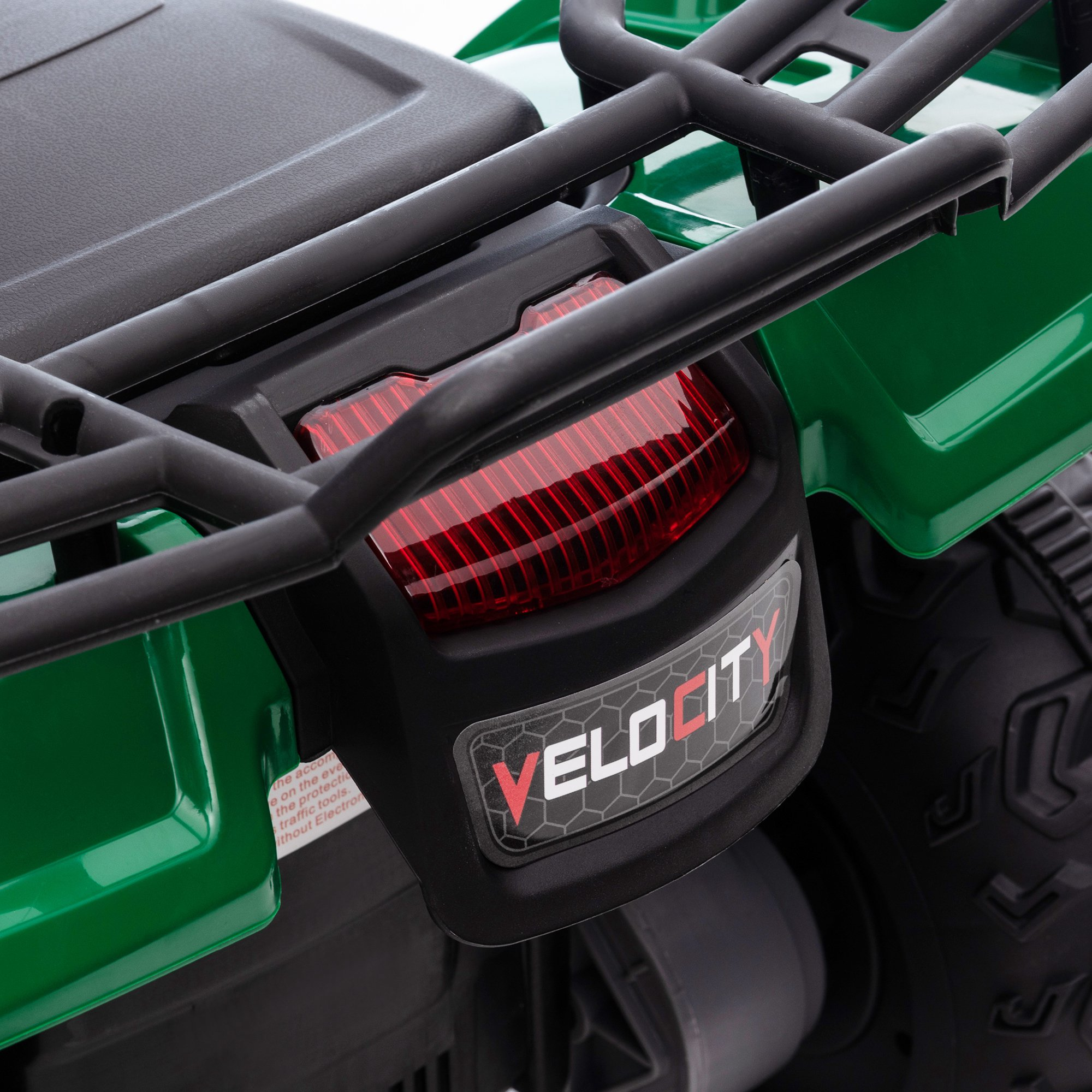 Primo piano del pannello di controllo di un ATV giocattolo verde con interruttori e pulsanti.