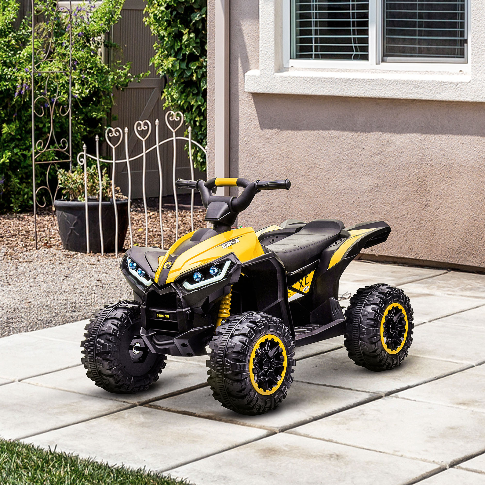 ATV giallo con dettagli neri, pneumatici neri e sospensioni gialle. Fari e la parola STRONG visibili.
