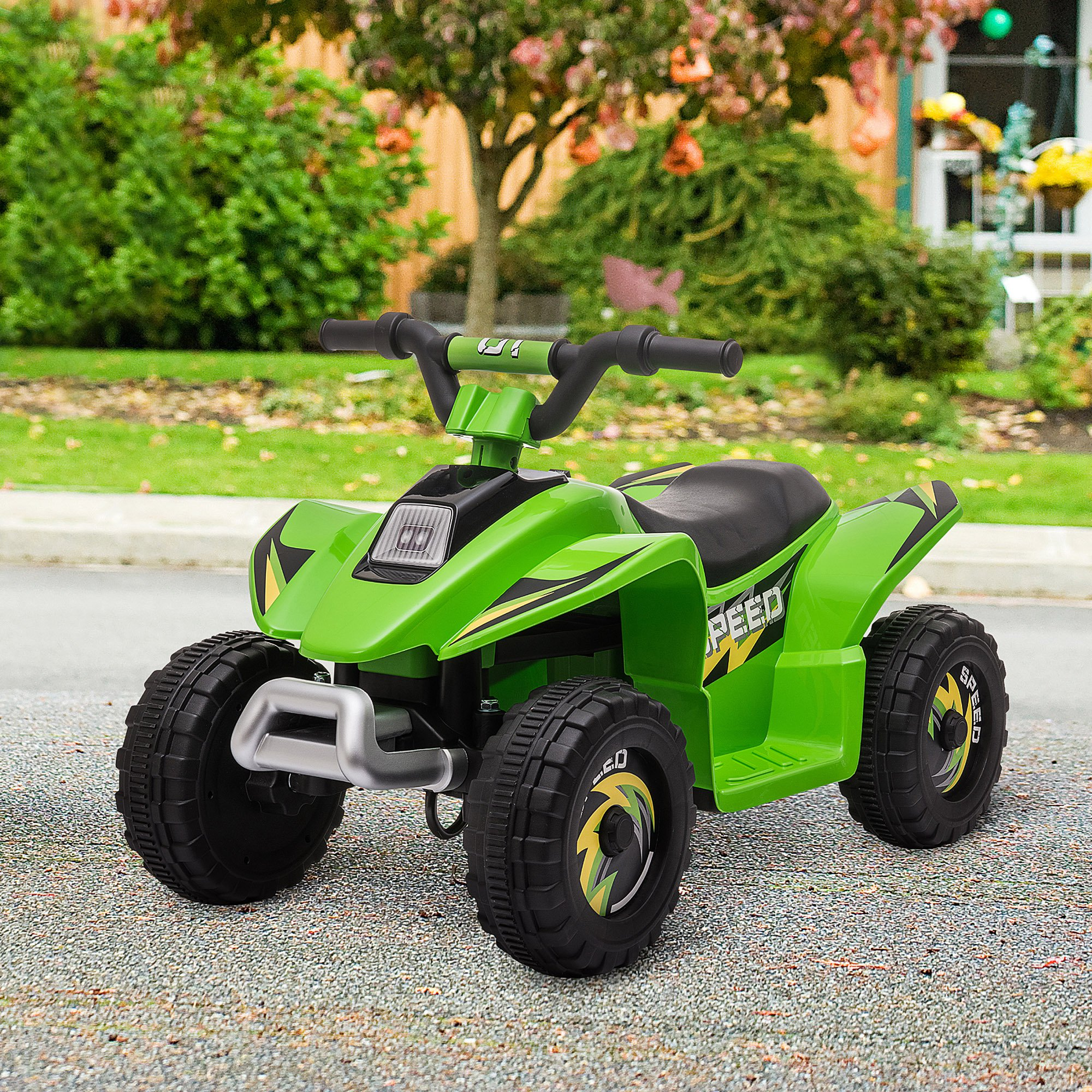 ATV giocattolo verde con dettagli neri. Accenti gialli sulle ruote e testo 'SPEED'. Su pavimentazione.