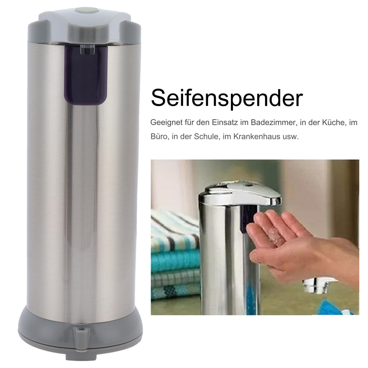 Ein silberner, zylindrischer Seifenspender mit grauem Sockel und lila Ausgabetaste.