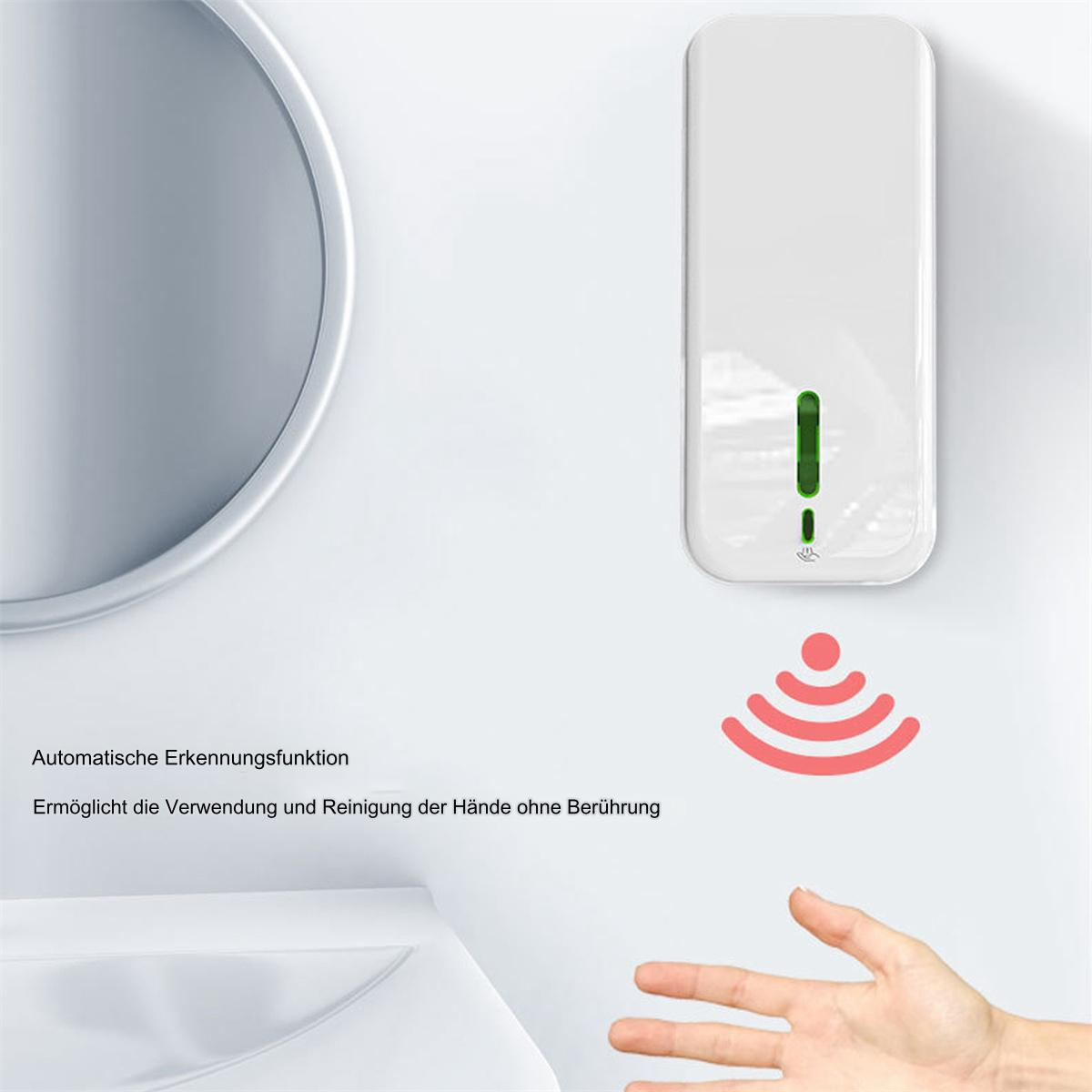 Weißer, wandmontierter Seifenspender mit Handgestensensor, an weißer Wand.
