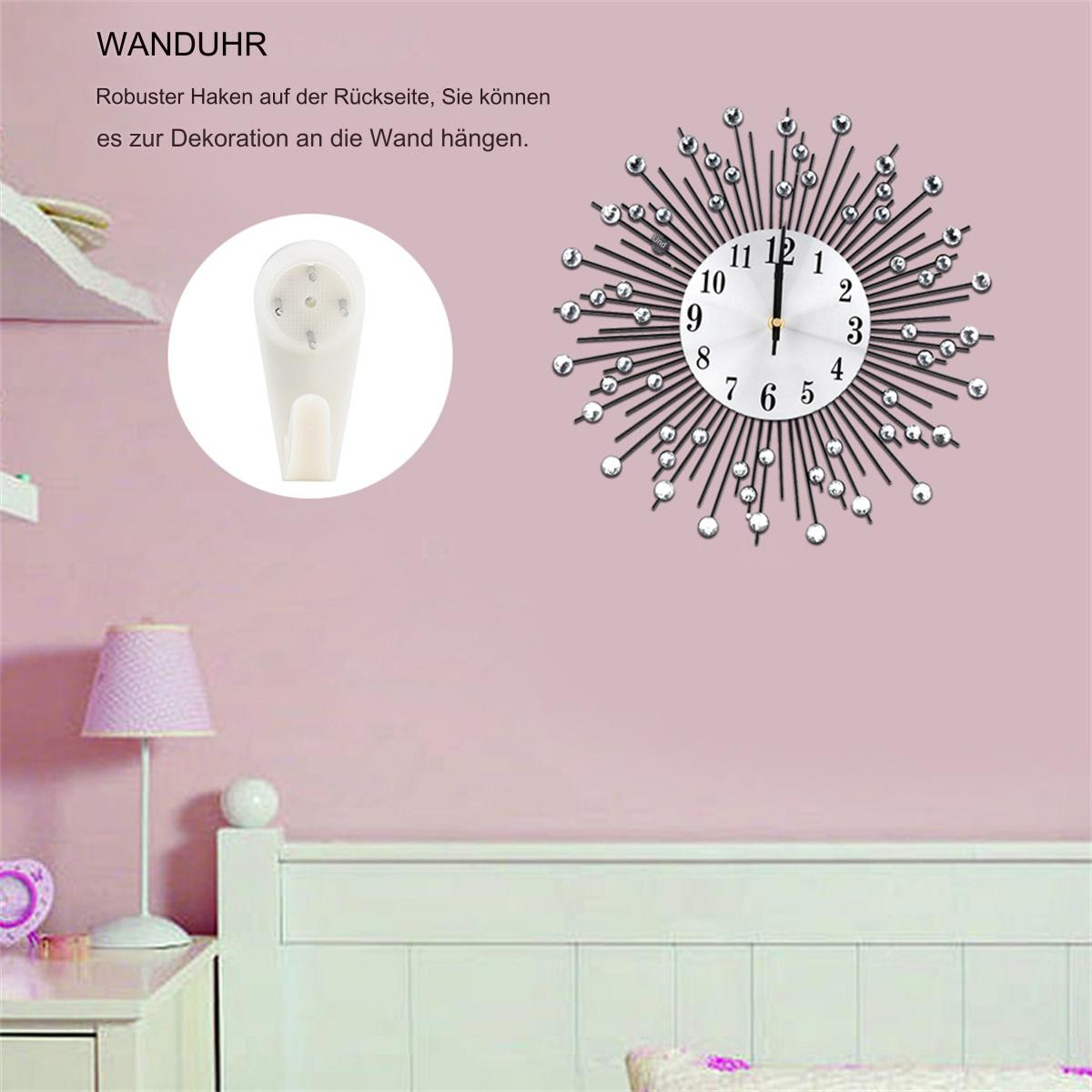 Eine Wanduhr mit kristallartigen Akzenten an einer rosa Wand. Ein Haken befindet sich in einem Kreis.