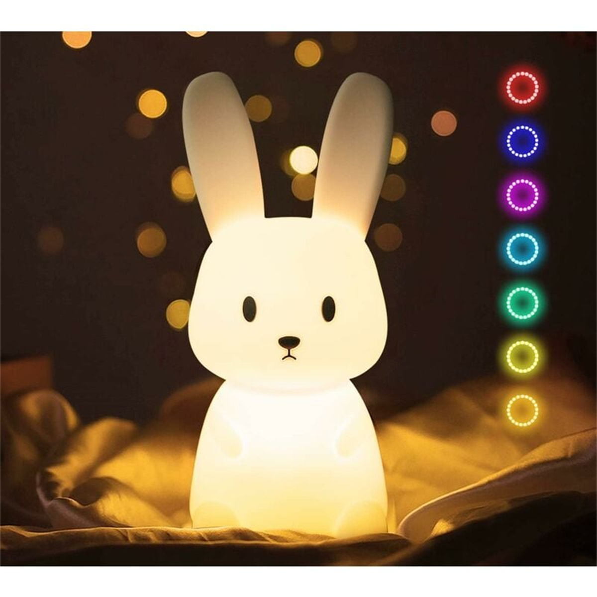 Ein weißes, hasenförmiges Nachtlicht mit Farboptionen, vor einem Bokeh-Hintergrund.