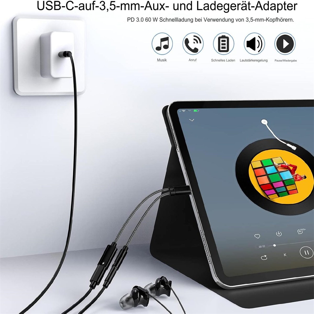 Schwarzes Ladekabel mit USB-C- und Aux-Anschlüssen und Ohrhörern neben einem Tablet.