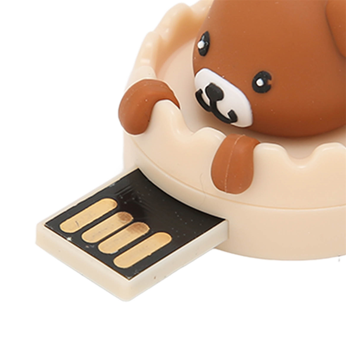 Ein brauner Bären-USB-Stick, teilweise in eine beige burgähnliche Basis eingesetzt.