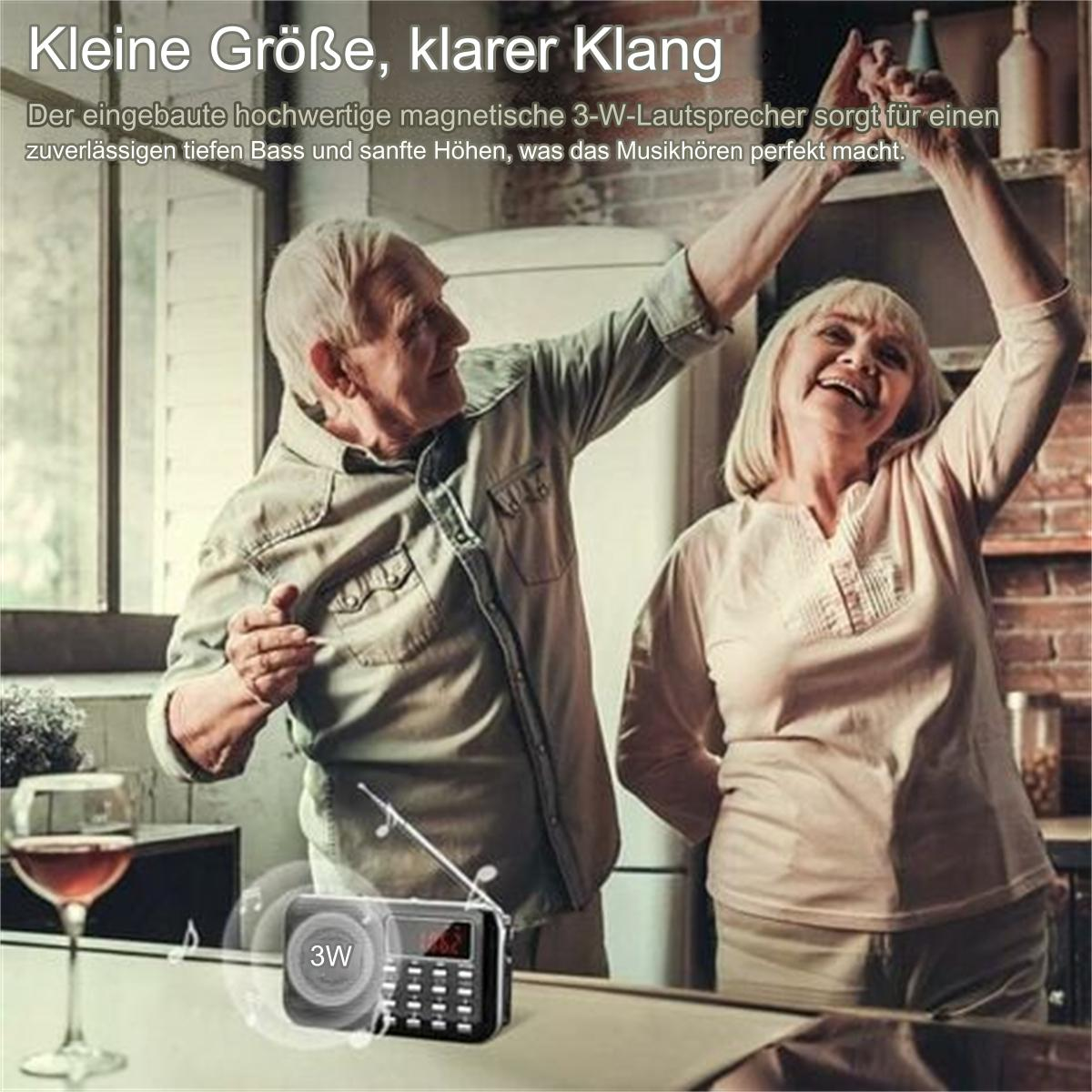 Ein älteres Ehepaar tanzt mit einem Radio auf dem Tisch. Das Radio ist klein und schwarz.