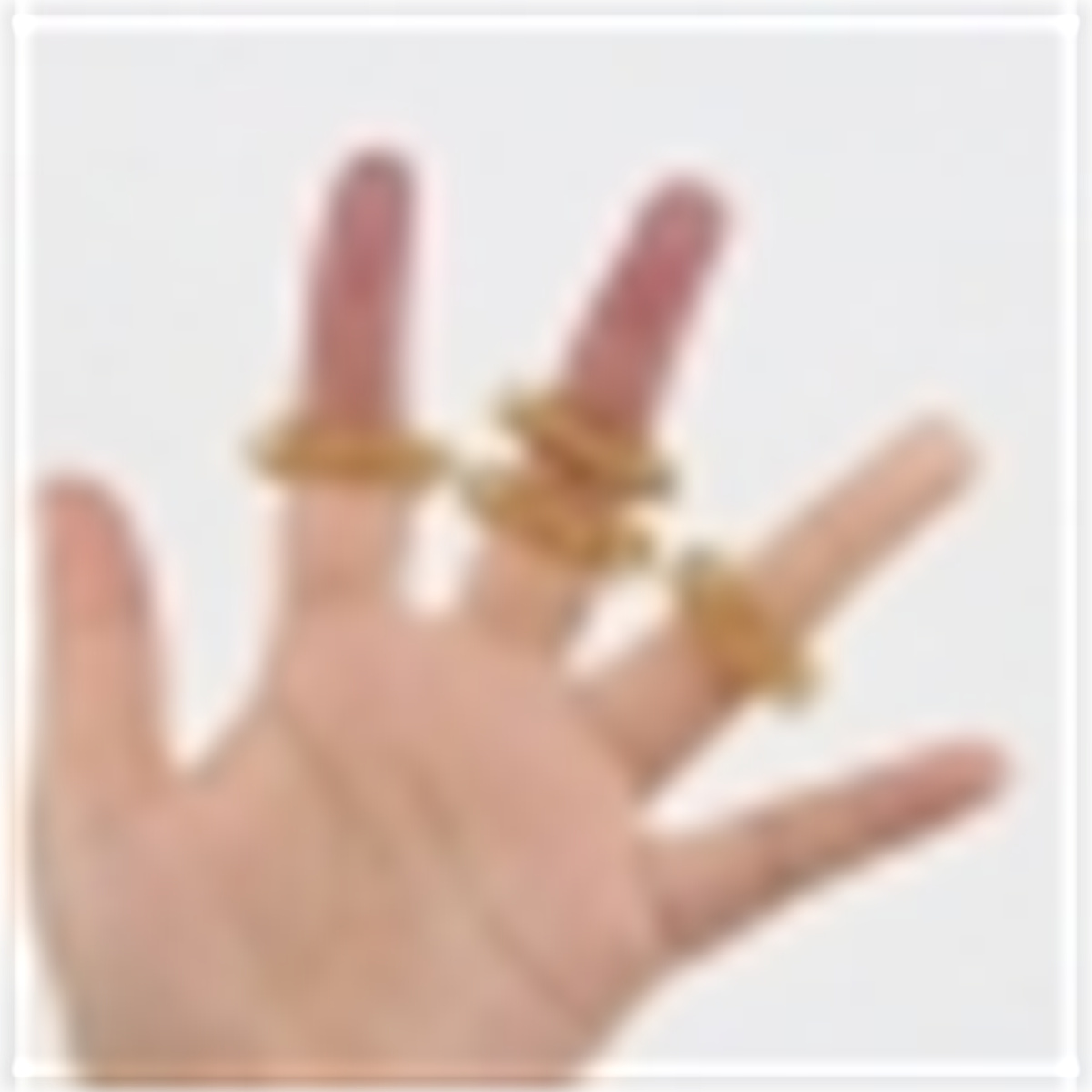 Hand mit Ringen an den Fingern. Ringe aus hellbraunem Material.