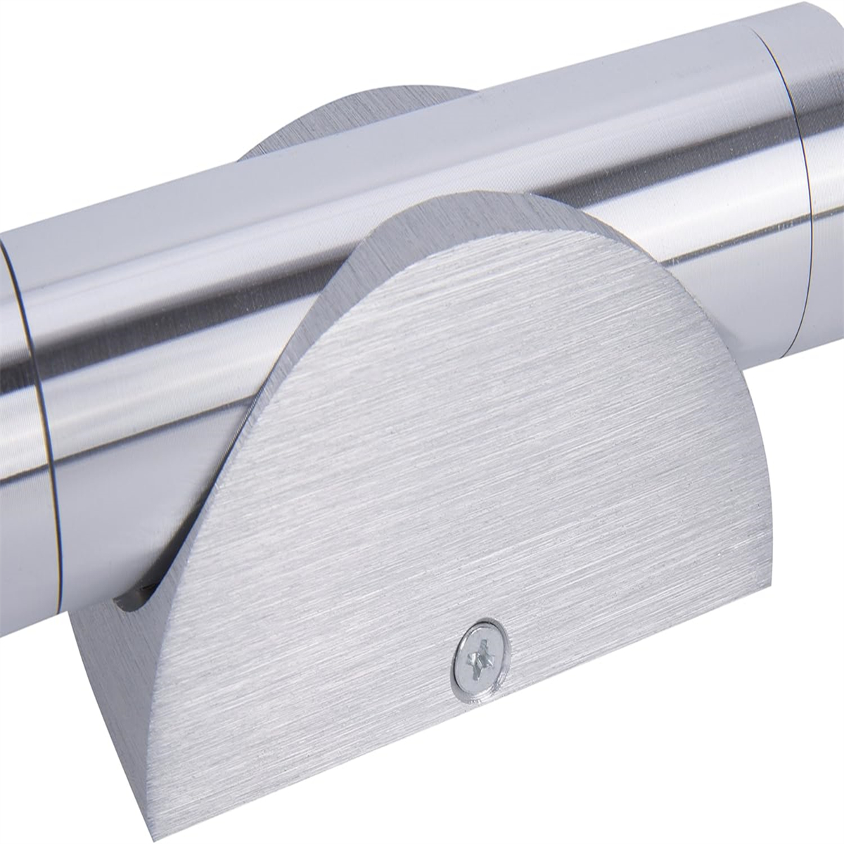 Silberne Leuchte. Eine zylindrische Leuchte mit gebürsteter Metalloberfläche. Sie ist an einer Wand montiert.