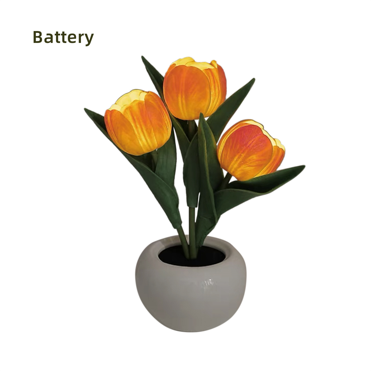 Drei künstliche orangefarbene Tulpen in einer weißen Vase, mit grünen Blättern. Das Wort 'Battery' steht oben.