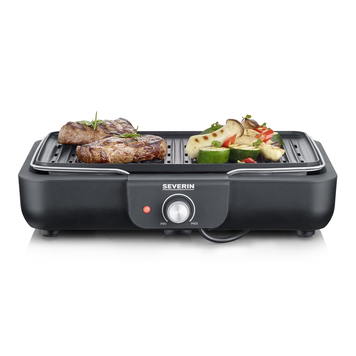 A black electric grill with steak and vegetables. It has a control dial.