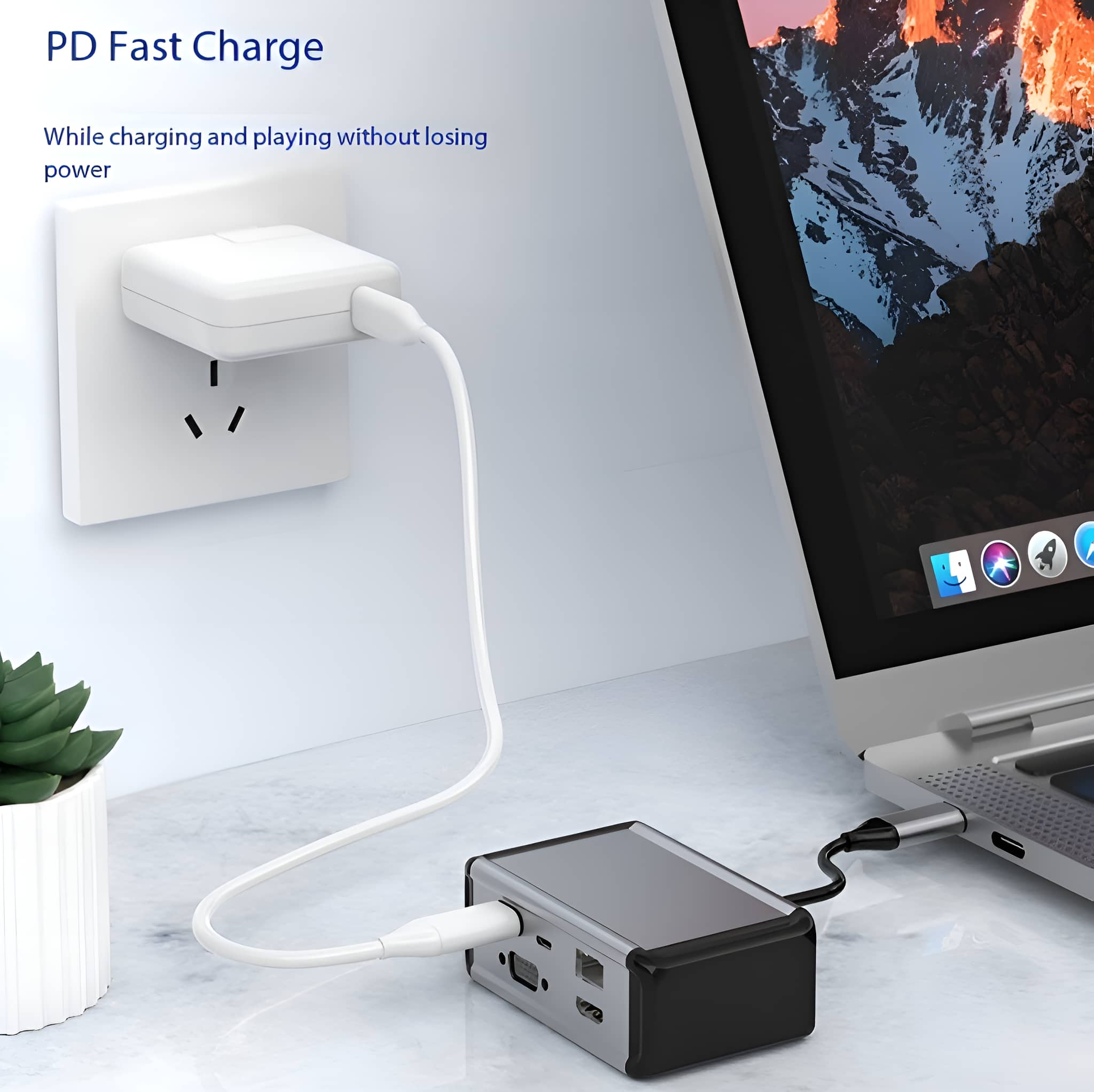 Laptop, der mit einem weißen Kabel von einem Wandadapter geladen wird. Auch eine kleine graue Box angeschlossen.