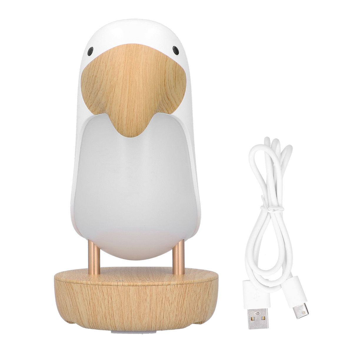 Ein weißes Pinguin-Nachtlicht auf einem Holzsockel, mit einem USB-Kabel daneben.