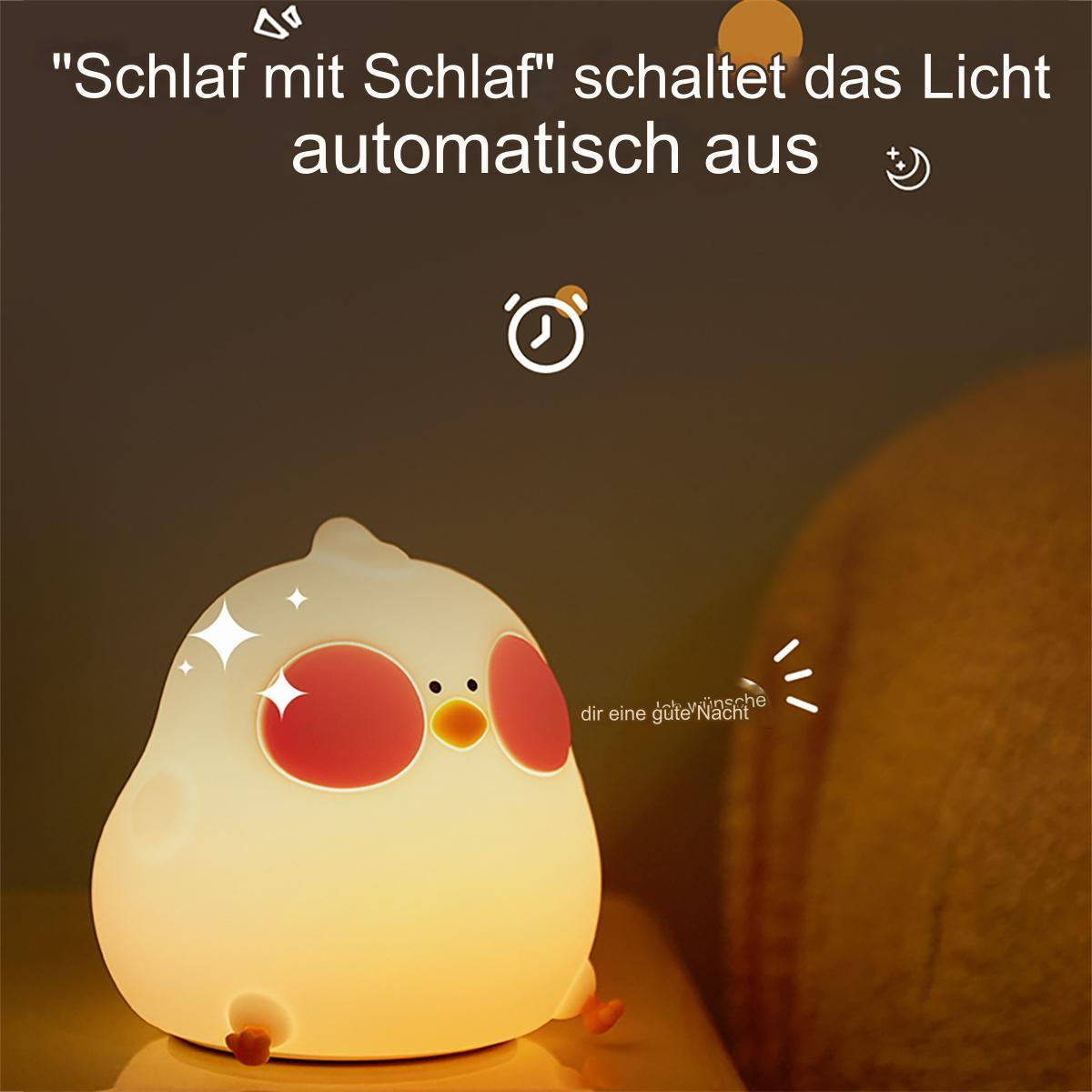 Ein Nachtlicht in Form eines Vogels mit Text darauf. Das Licht befindet sich auf einer Oberfläche.