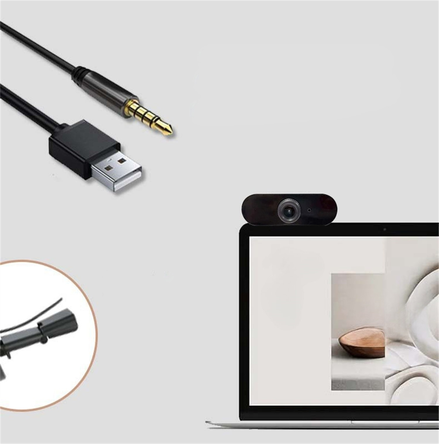Webcam an einem Laptop, verbunden über USB und Audioanschluss. Schwarzes Kabel und Stecker.