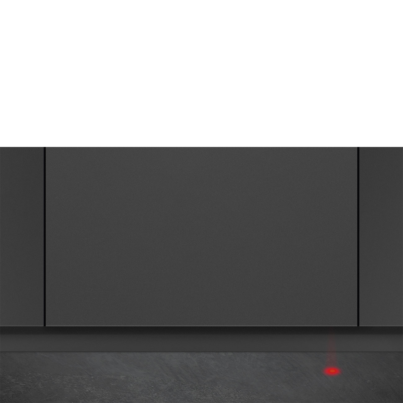 Un muro grigio scuro con una luce rossa in basso su una superficie grigia.
