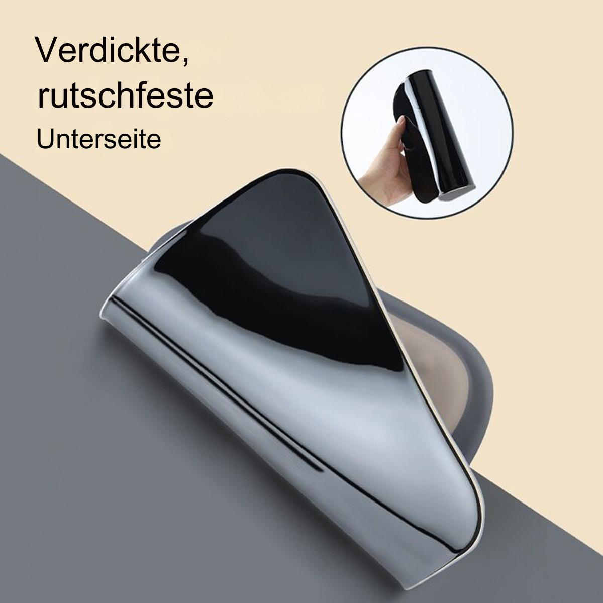 Eine schwarze Seifenschale, dick und rutschfest. Sie hat ein gebogenes Design und eine reflektierende Oberfläche.