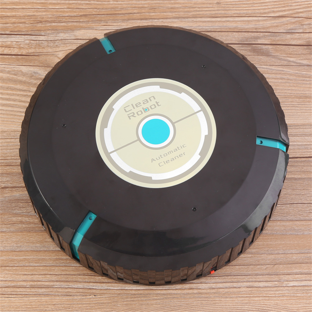 Schwarzer Roboter-Staubsauger mit zentralem Logo und blauen Akzentlichtern auf Holz.
