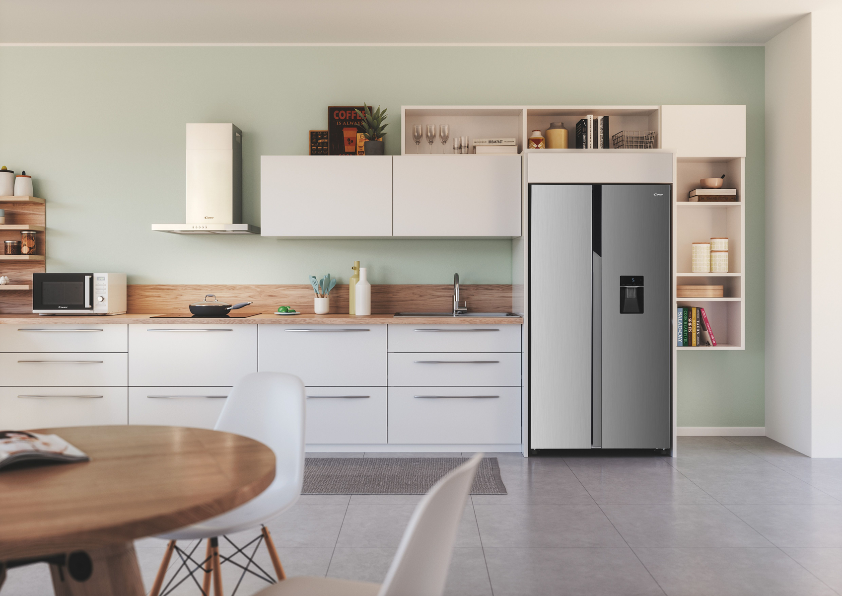 Una cucina moderna con mobili bianchi, un frigorifero in acciaio inossidabile e un tavolo rotondo in legno.