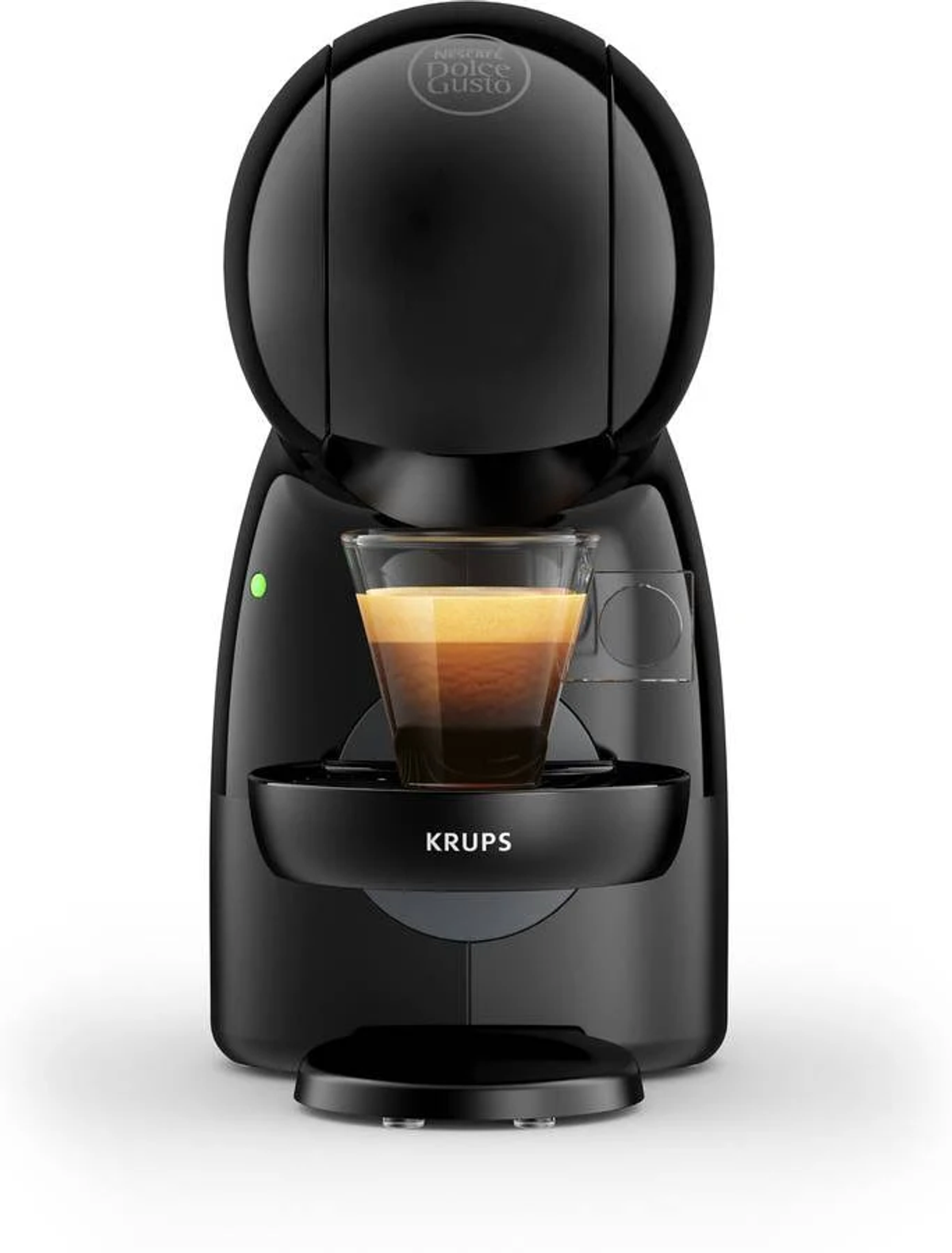 Una macchina da caffè Krups Nespresso nera con un bicchiere di caffè. Illuminata da luce verde.