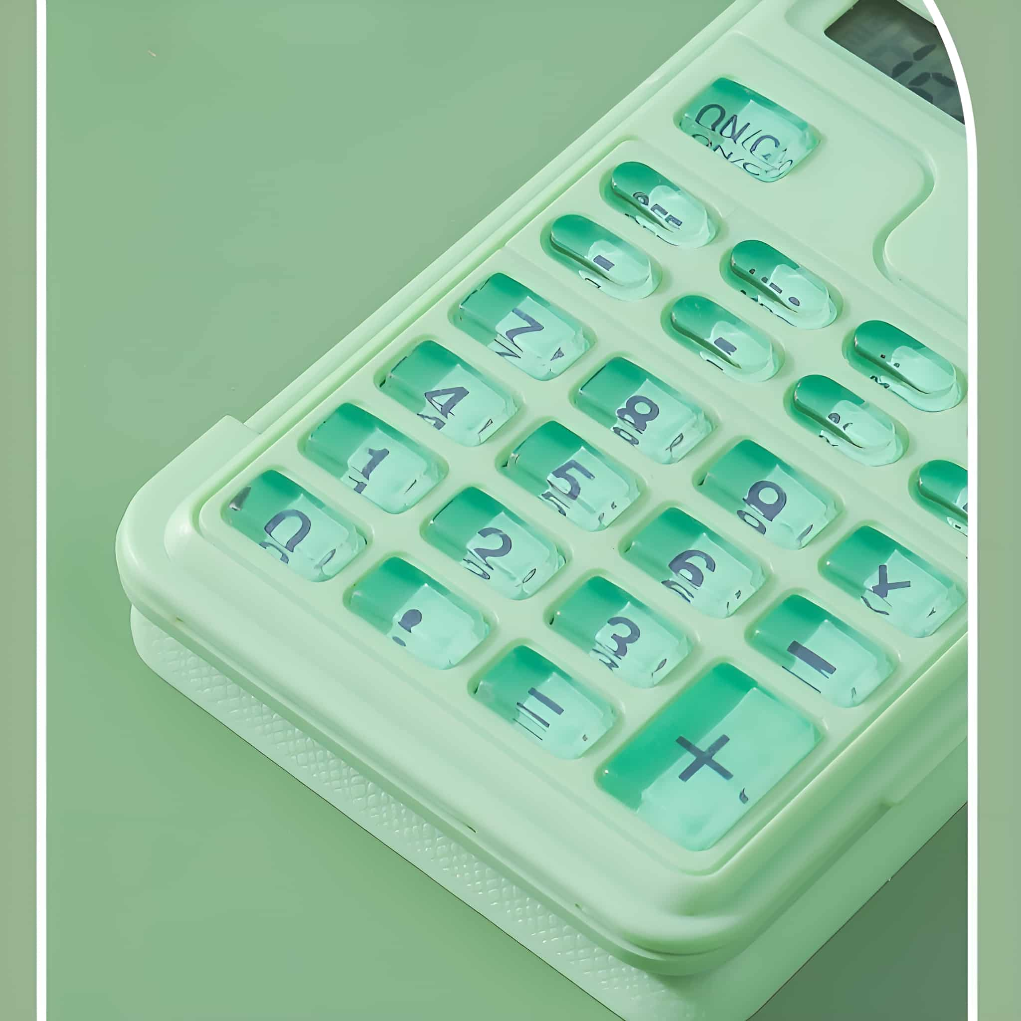 Grüner und weißer Taschenrechner mit pillenförmigen Tasten, Draufsicht.