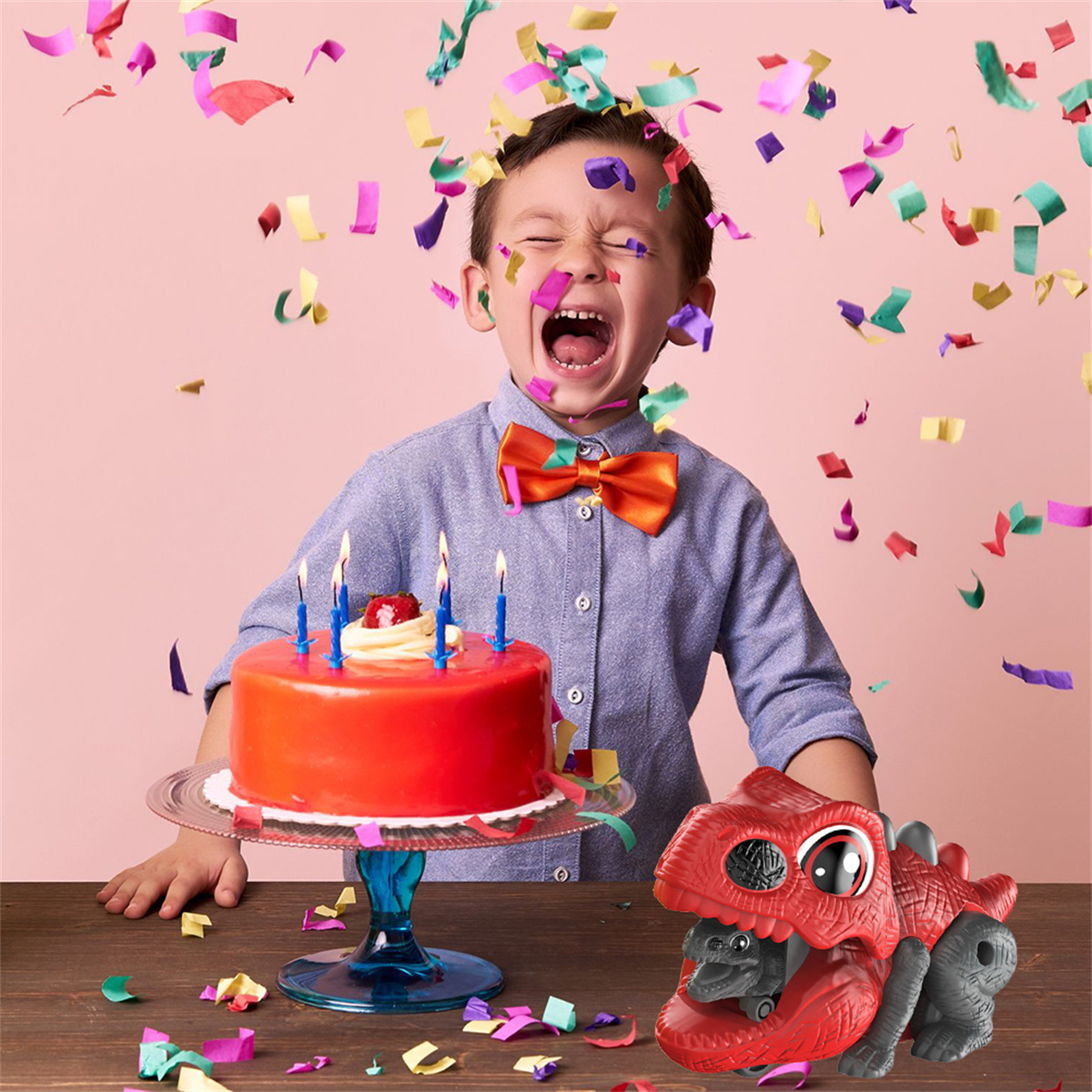 Ein Kind feiert Geburtstag mit Kuchen und Dinosaurier-Spielzeug, Konfetti in der Luft.
