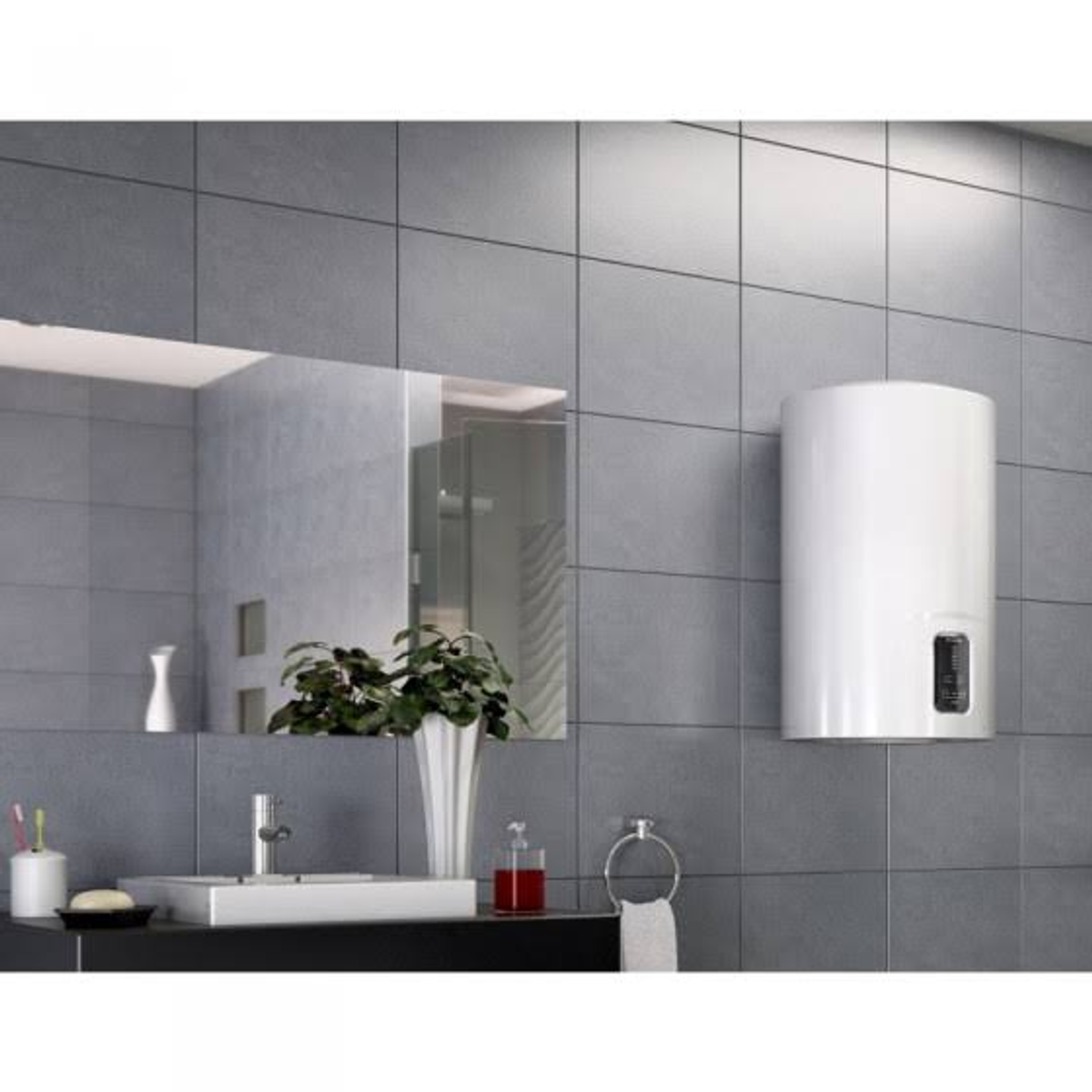 Calentador de agua blanco montado en pared de azulejos grises, con espejo y lavabo al fondo.