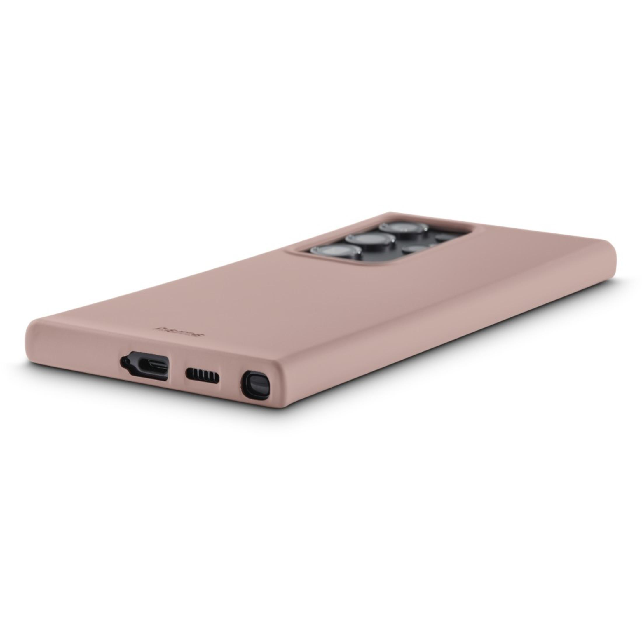 Coque de téléphone rose avec objectifs d'appareil photo. Elle est posée sur une surface blanche.