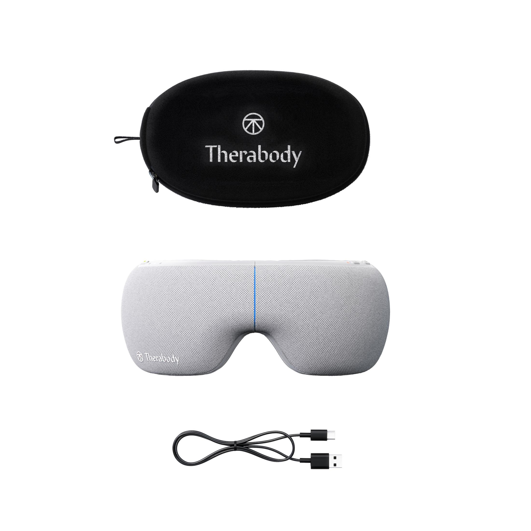 Una máscara para ojos gris con estuche negro y cable cargador USB. La máscara dice 'Therabody'.