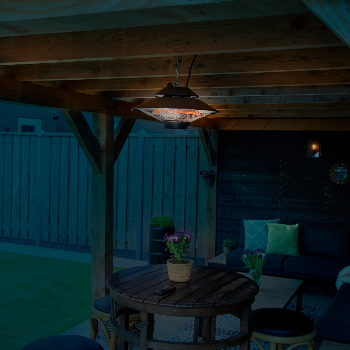 Outdoor heater hanging from wooden beams, with lights on, in a dark environment.