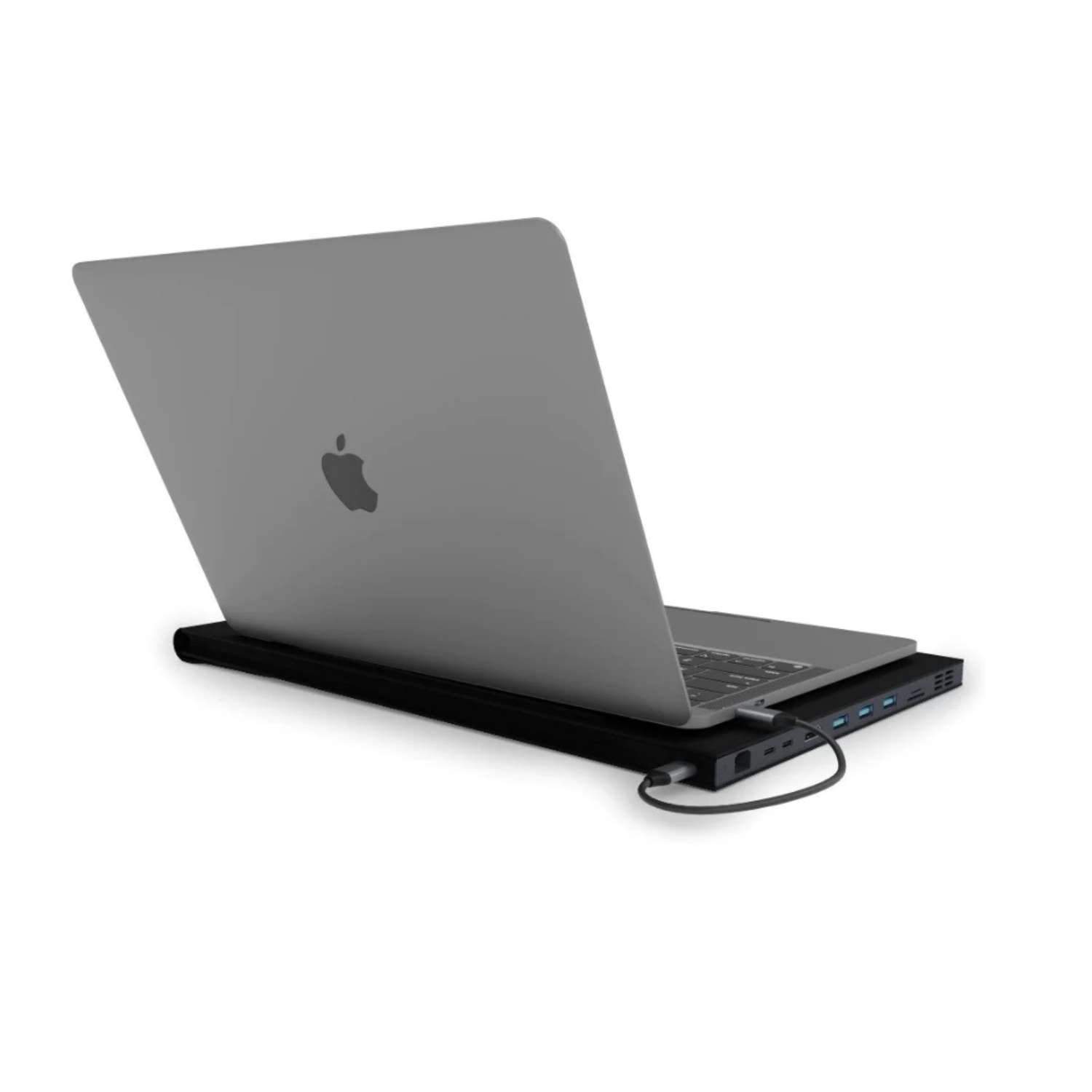 Laptop on a black stand with USB ports and a charging cable.