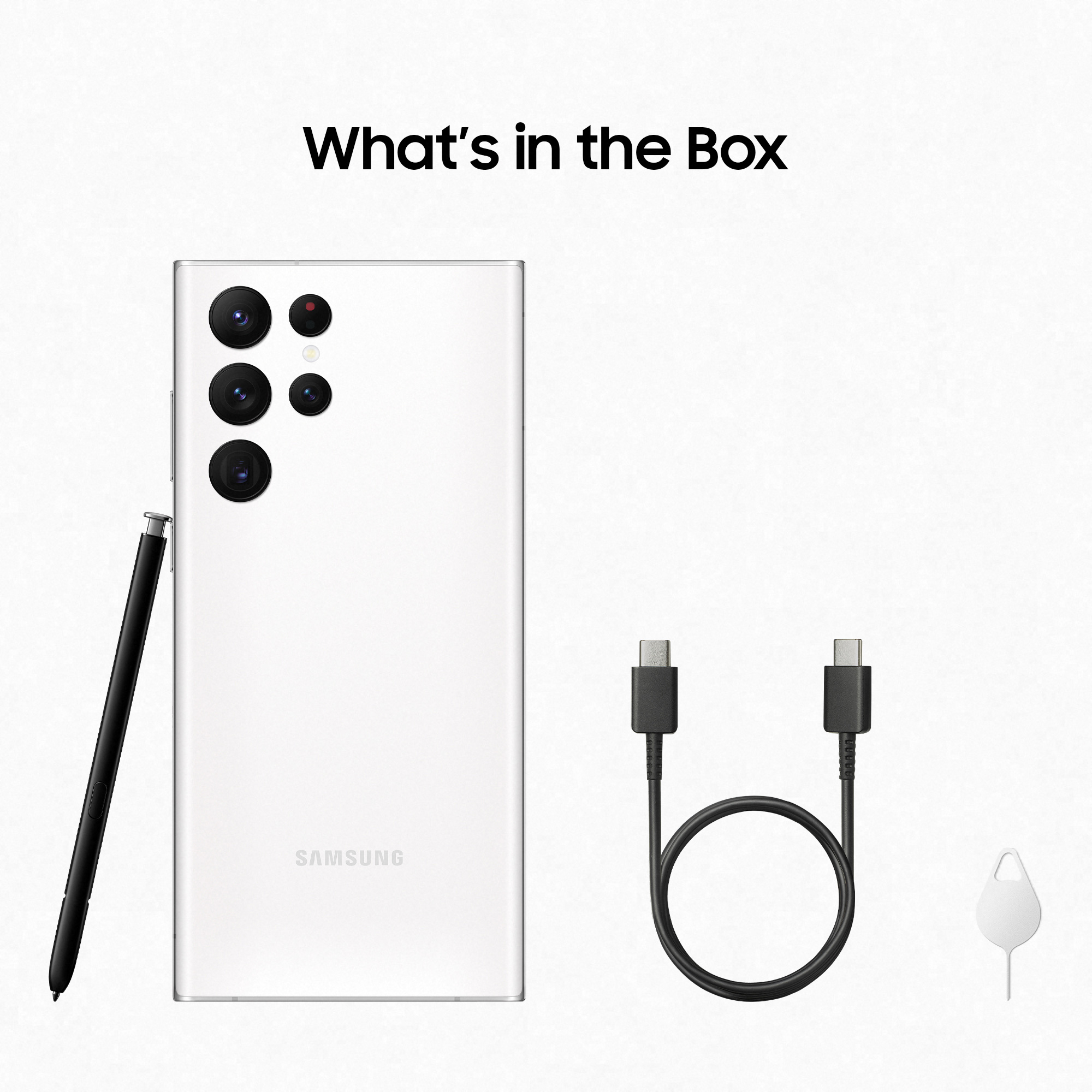 Biały smartfon i akcesoria: rysik, kabel ładujący i narzędzie do wysuwania karty SIM.