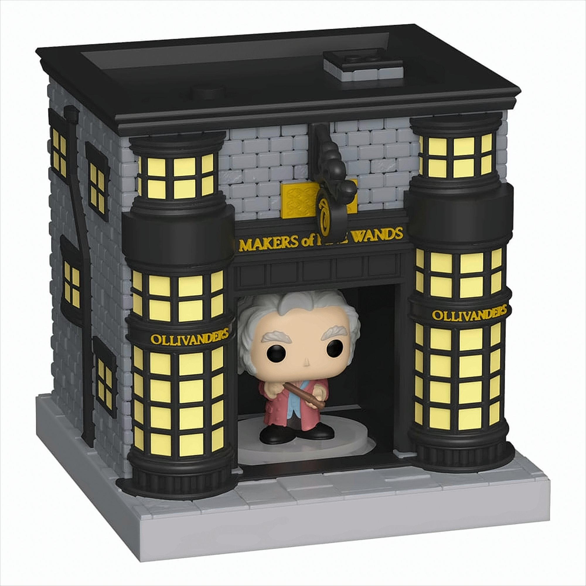 Miniatura del negozio Ollivanders con una figura che tiene una bacchetta. L'edificio è in mattoni, con torri.