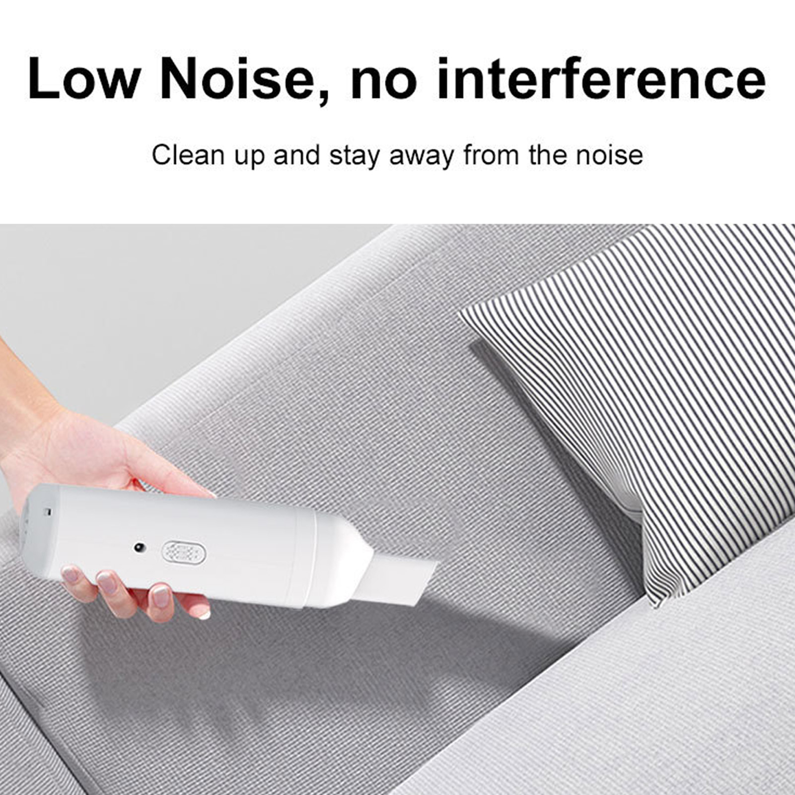 Eine Hand benutzt einen weißen Staubsauger auf einem grauen Sofa. Ein Kissen ist im Hintergrund. Der Text 'Low Noise' ist sichtbar.