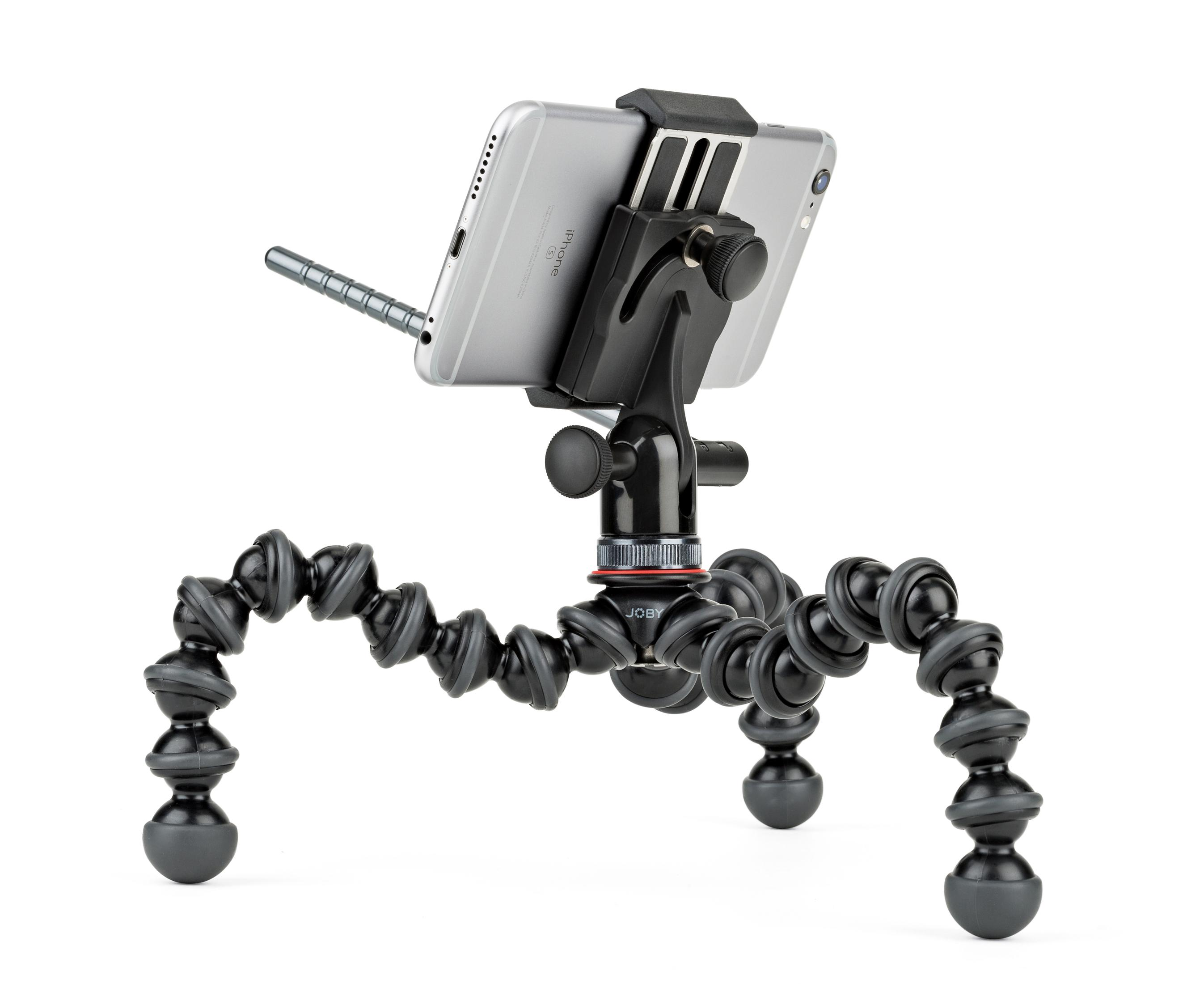 Telefon zamontowany na elastycznym statywie z giętkimi nogami na białym tle.