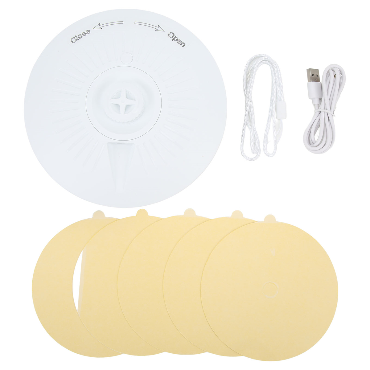 Weißer Deckel mit kreuzförmigem Design, gelbe Scheiben, eine Schnur und ein USB-Kabel.