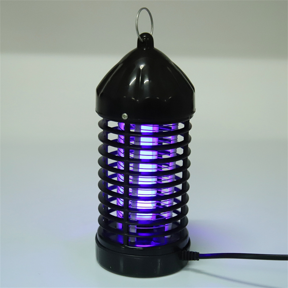 Schwarze elektrische Mückenfalle mit lila Licht, isoliert auf weißem Hintergrund.
