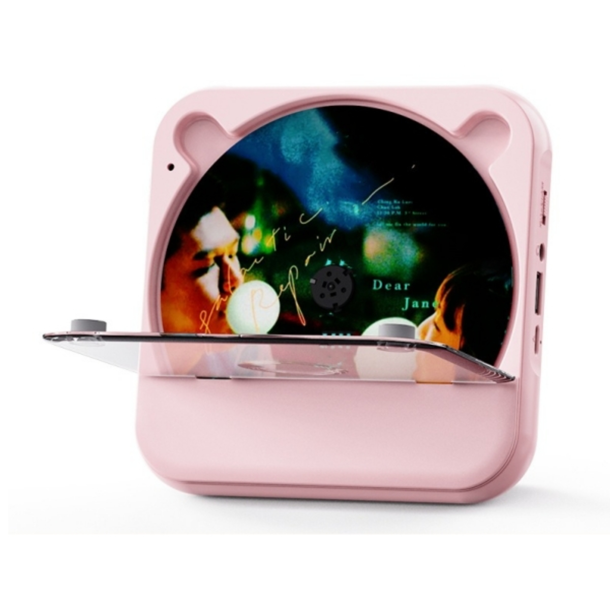 Ein rosa, bärenförmiger CD-Player mit Bildschirm und transparenter Abdeckung, der eine CD abspielt.