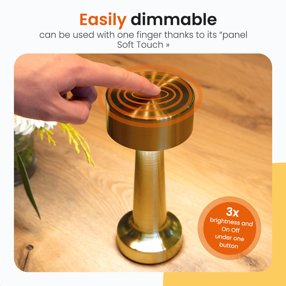 Gold-colored table lamp, with a finger touching the top, and text about dimming.