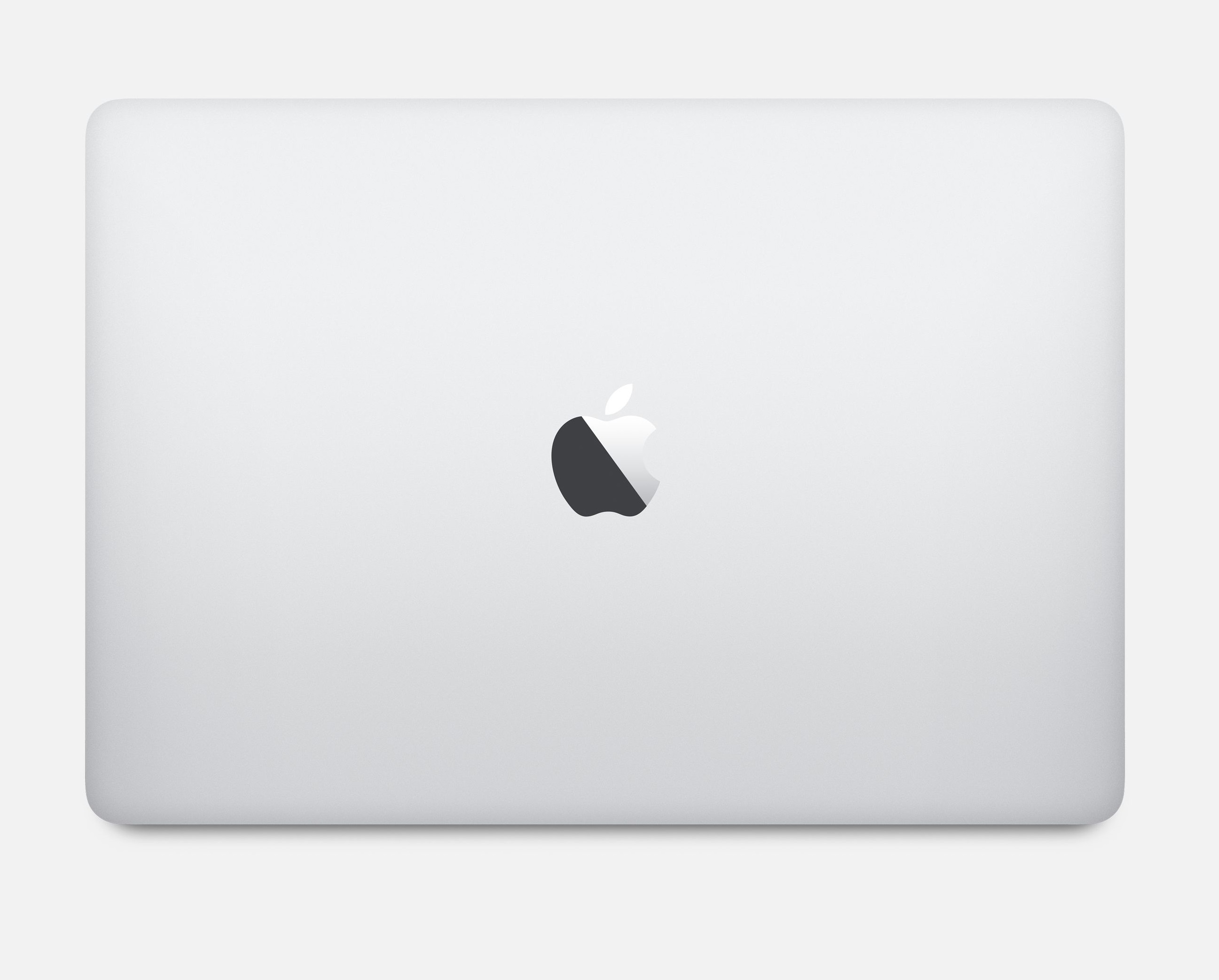 Zamknięty, biały MacBook z logo Apple. Białe tło. Widok z góry.