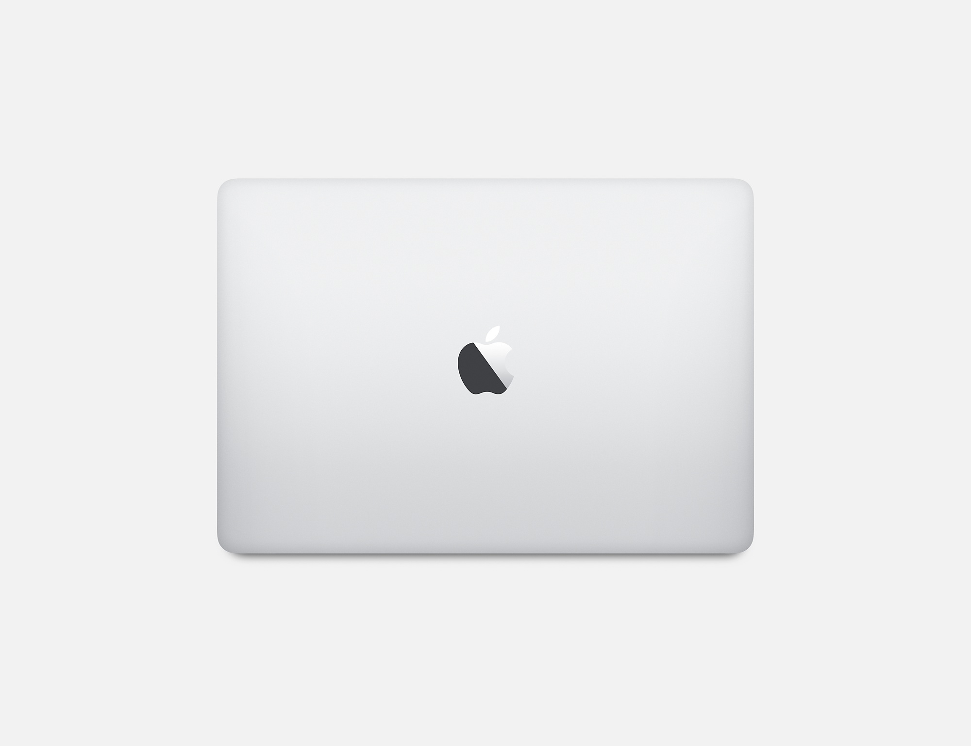 Srebrny laptop z czarnym logo Apple na górze, widok z góry na białym tle.