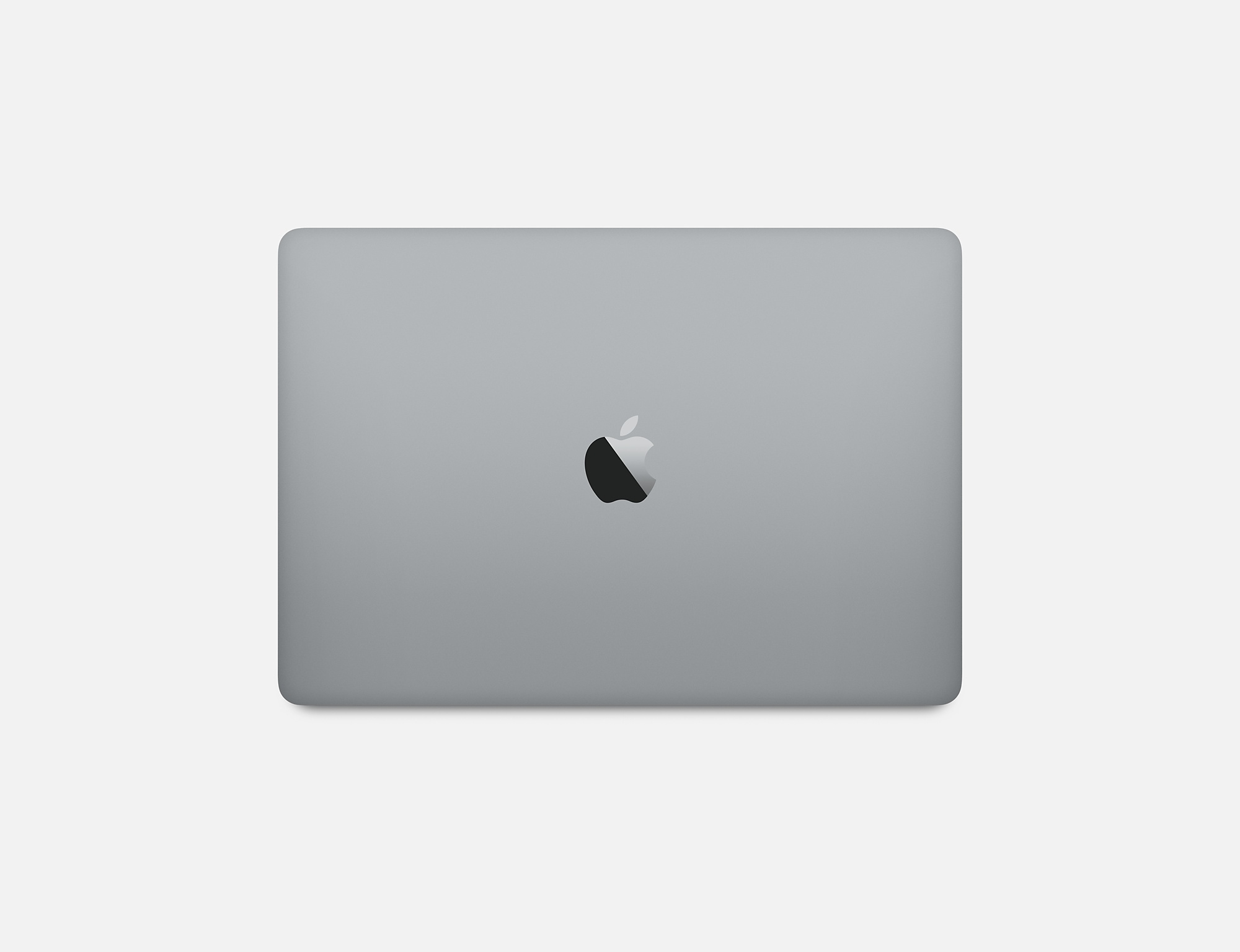 Zamknięty srebrny laptop, z logo Apple, na białej powierzchni.