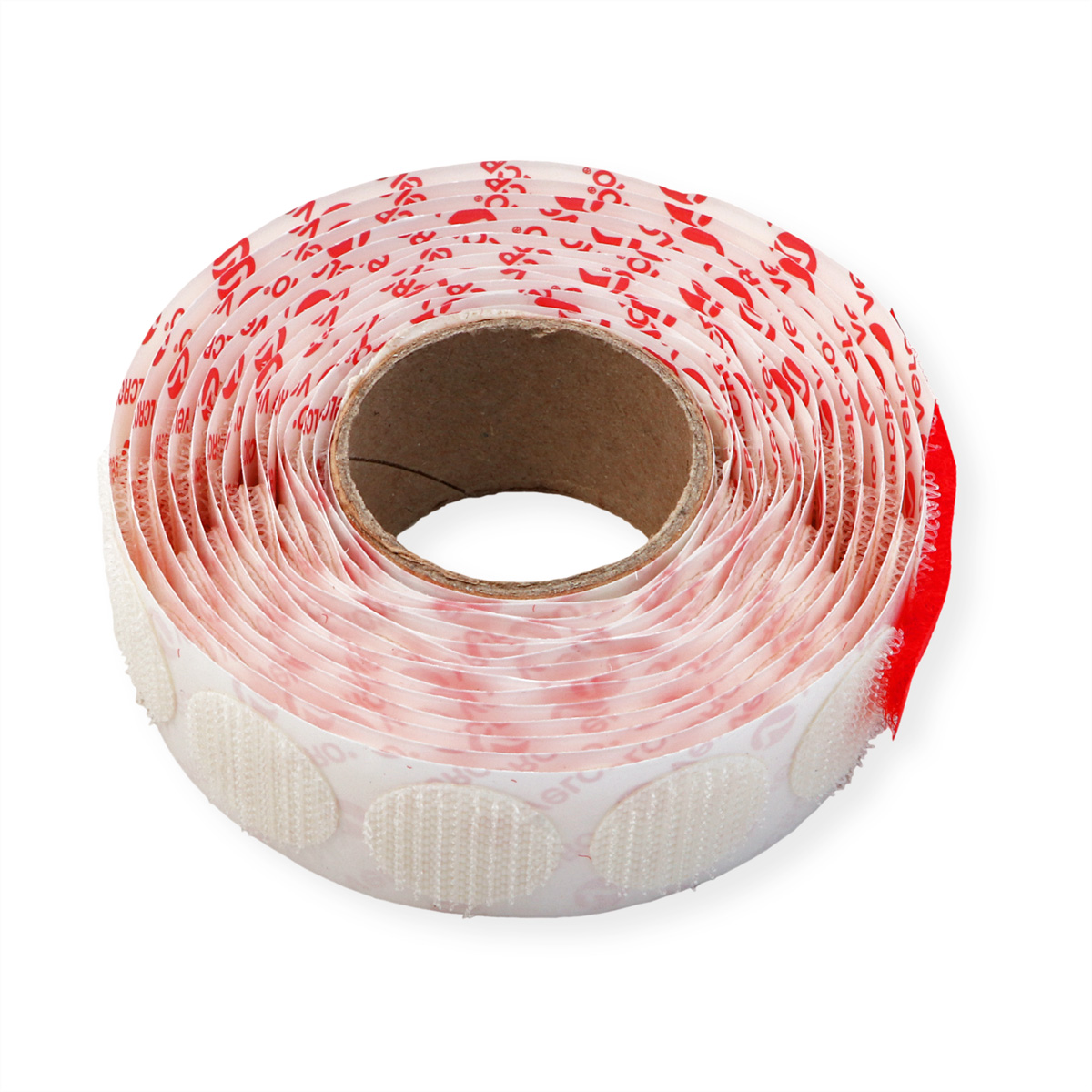 Rolle weißer Klettverschlüsse, rotes Druckmuster und ein Pappkern.