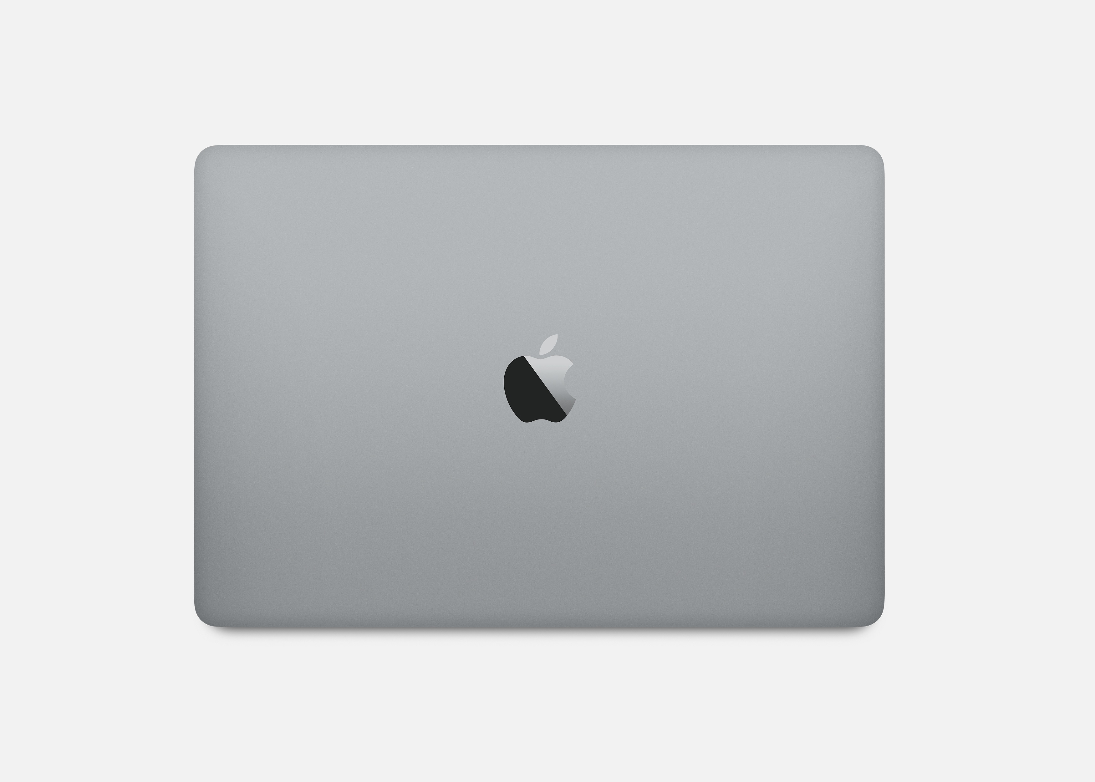 Vista dall'alto di un laptop grigio. Logo Apple al centro. Sfondo bianco.