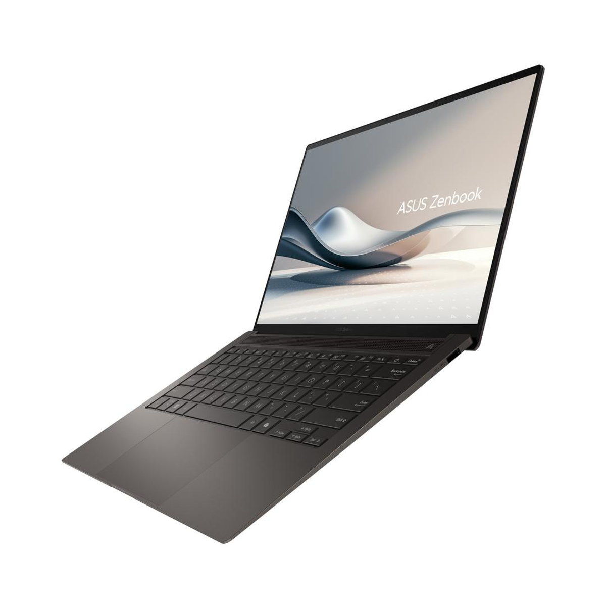 Portátil negro, en ángulo con la pantalla abierta, mostrando el teclado y el logo de Asus Zenbook.